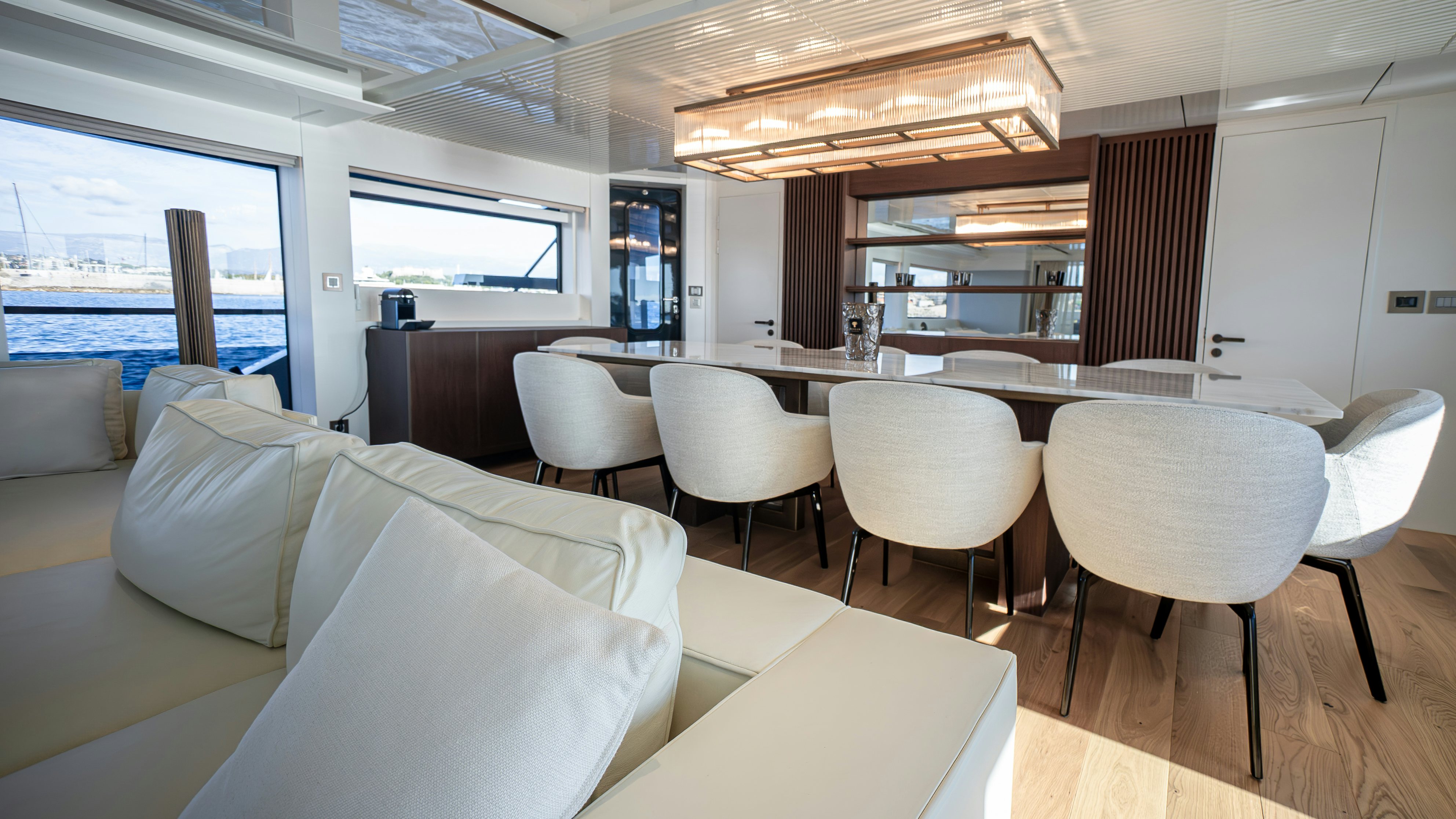a room with a table chairs and a window aboard RAY Yacht for Sale