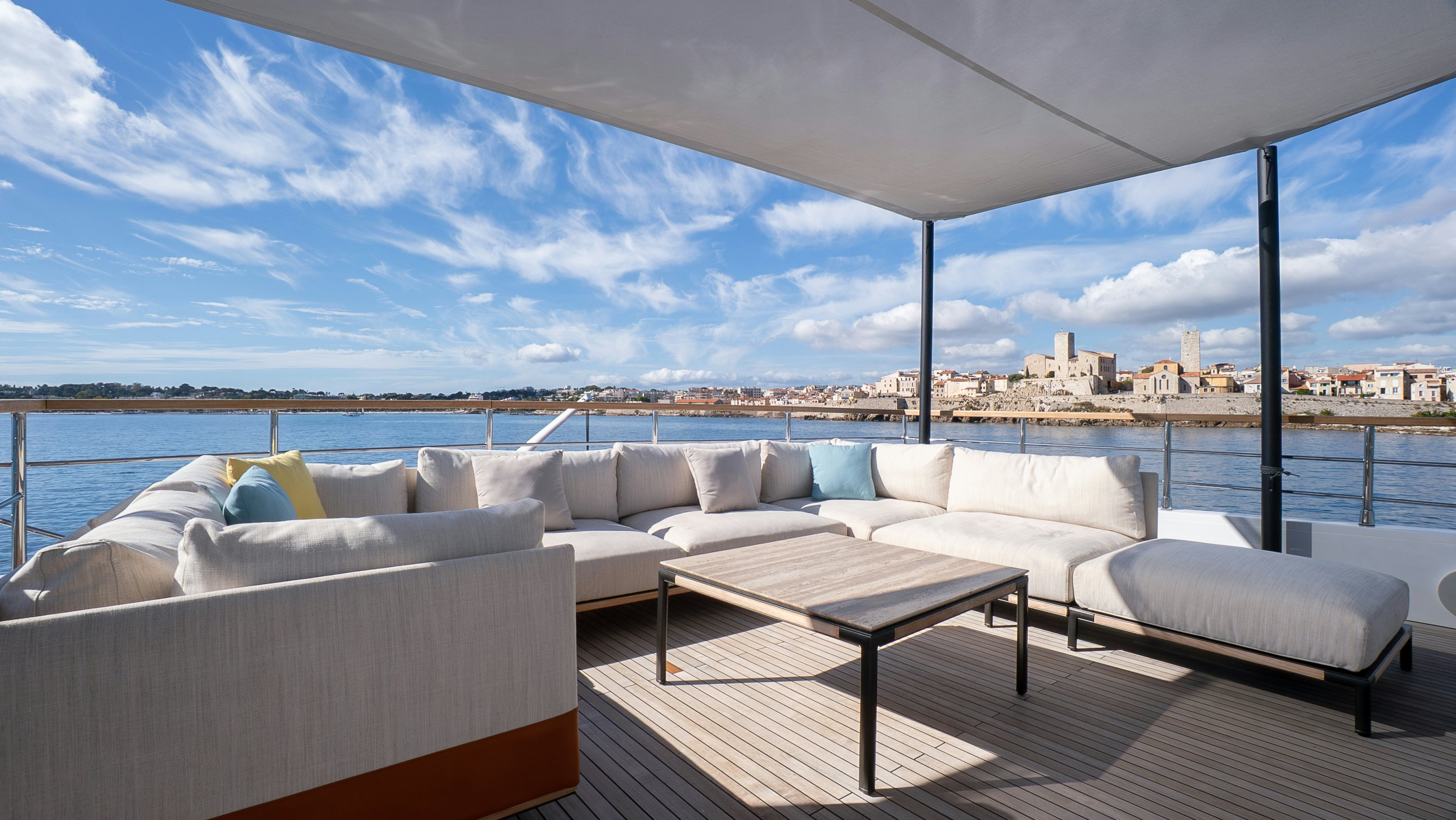 a large white couch with a table in front of it aboard RAY Yacht for Sale