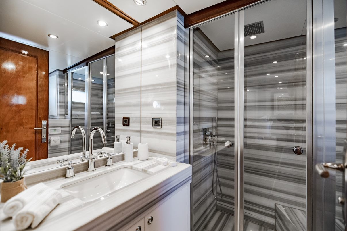 a bathroom with a glass shower aboard ALHAMBRA Yacht for Charter