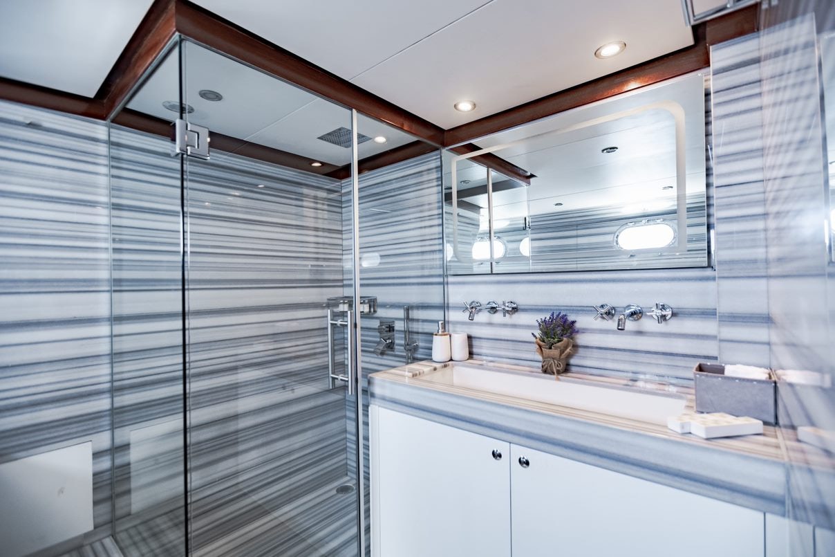 a bathroom with a glass shower aboard ALHAMBRA Yacht for Charter