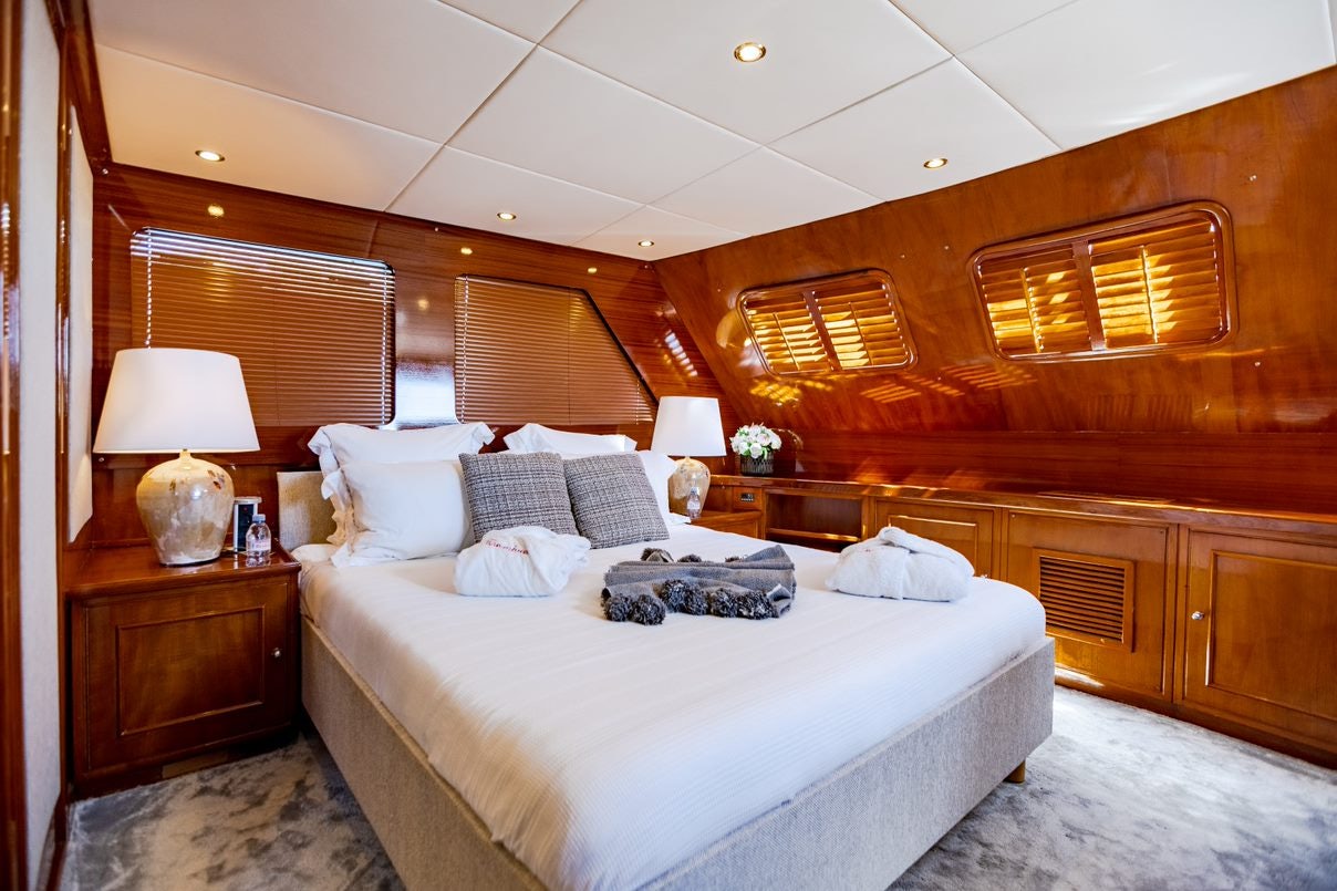 a room with a bed and a lamp aboard ALHAMBRA Yacht for Charter