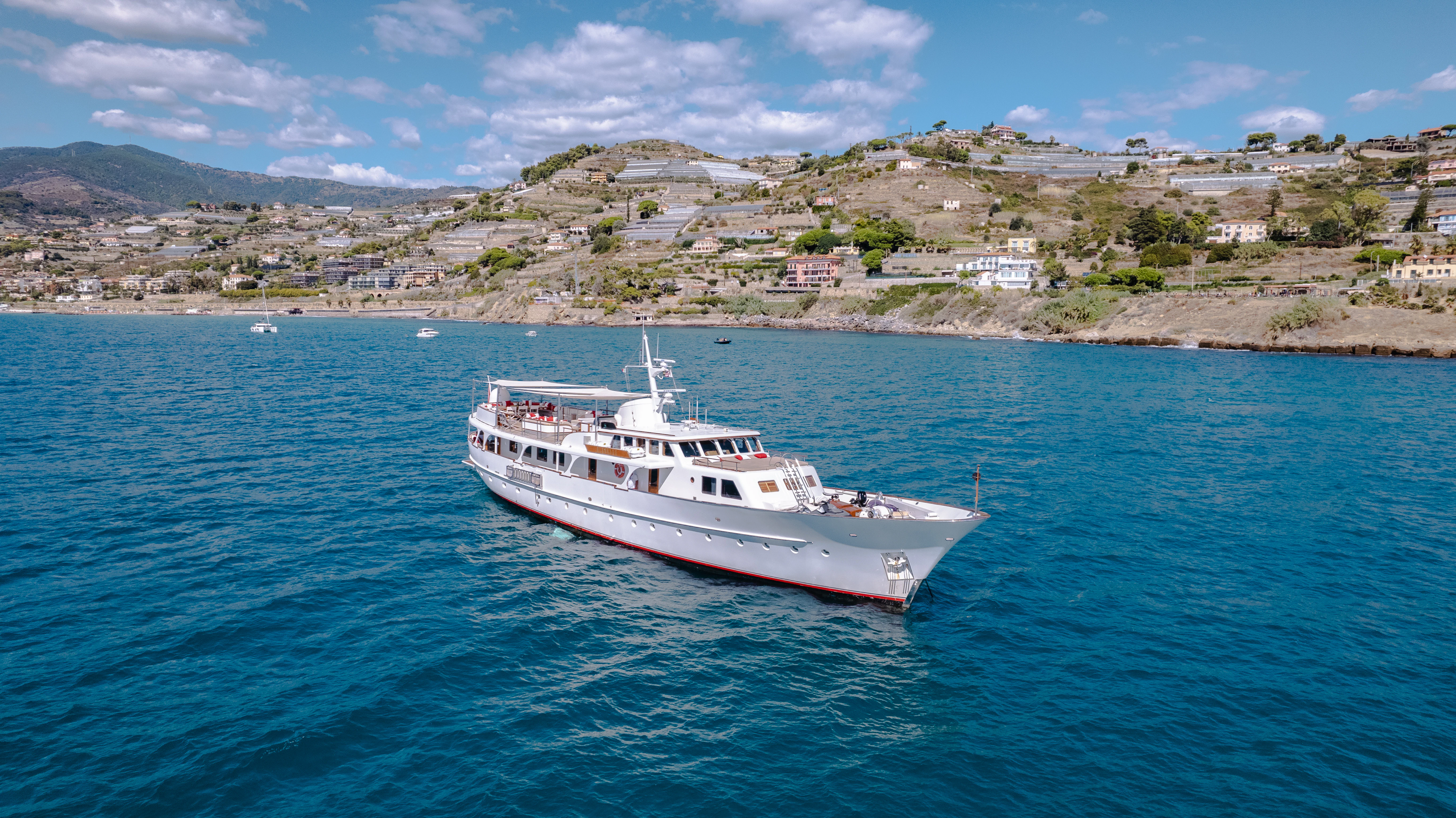 a white boat on the water aboard ALHAMBRA Yacht for Sale