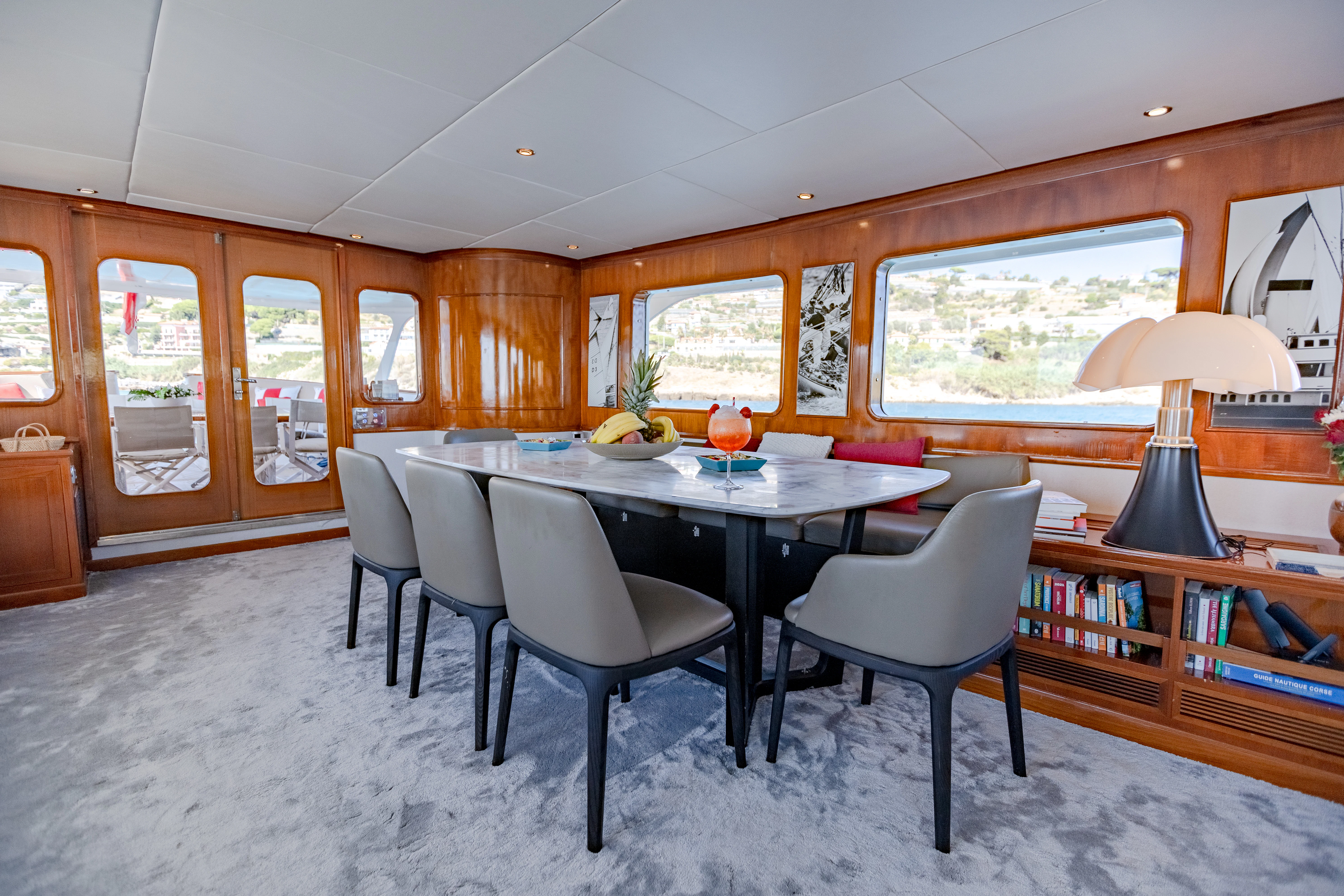 a dining room with a table and chairs aboard ALHAMBRA Yacht for Sale