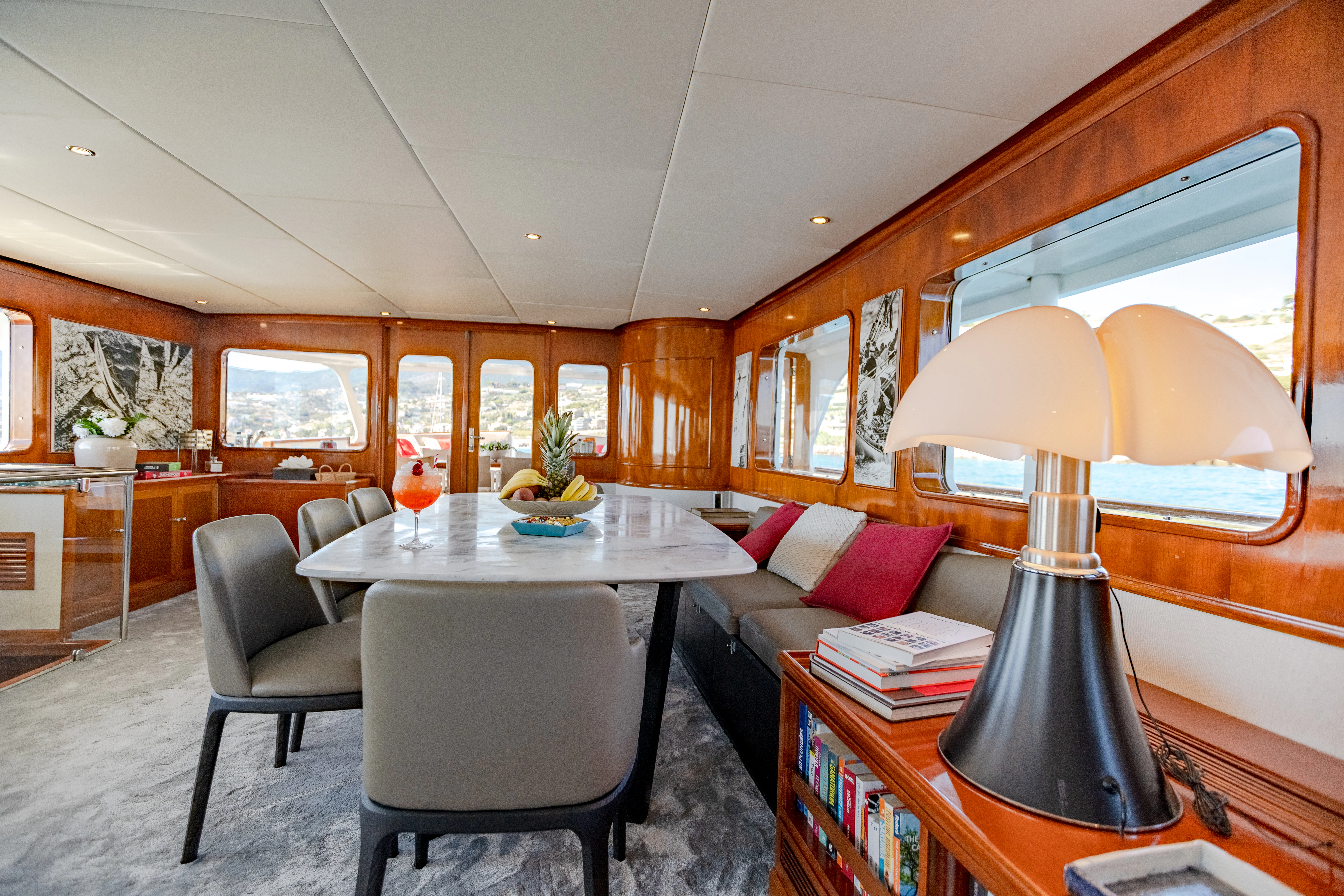 a living room with a table and chairs aboard ALHAMBRA Yacht for Sale