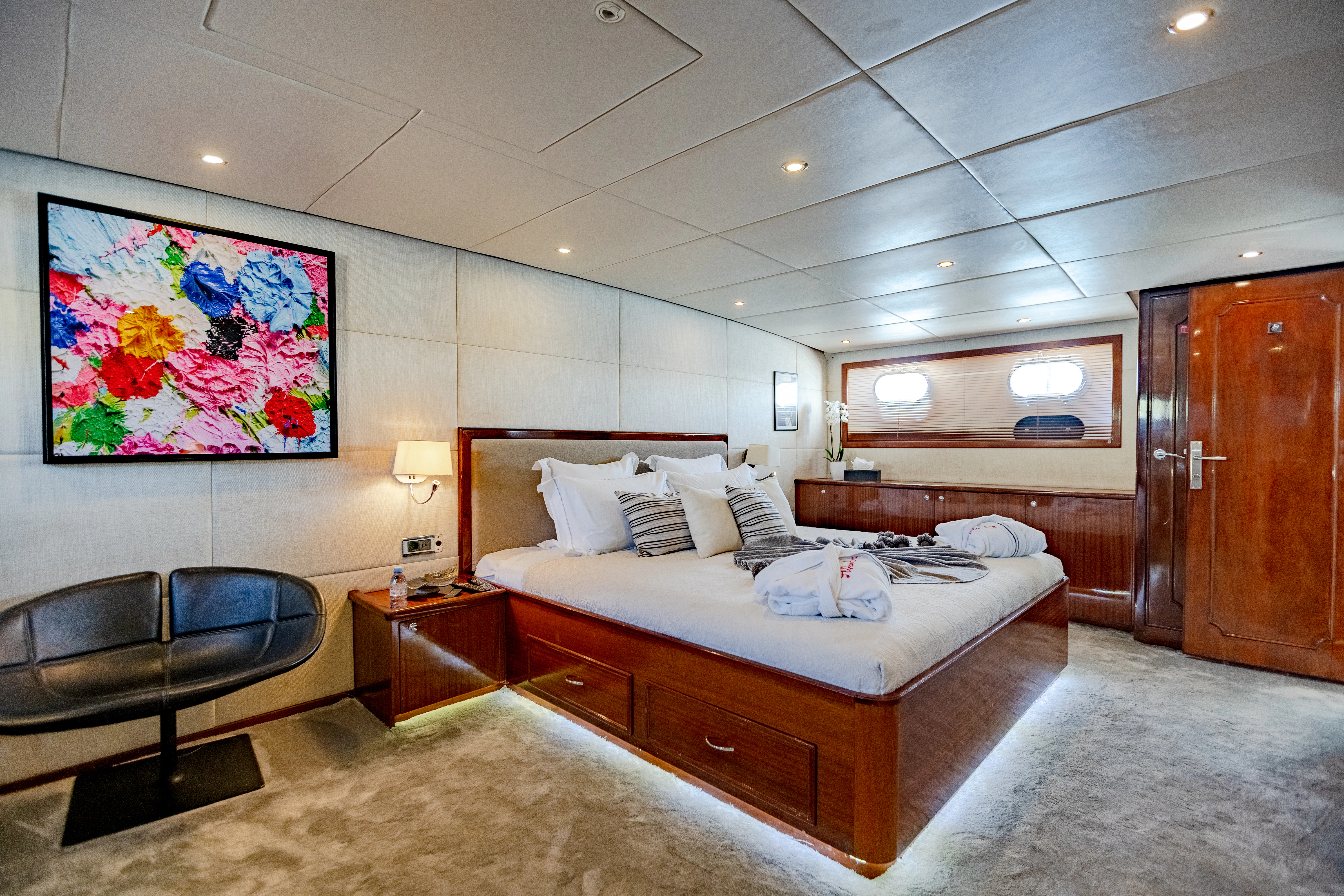 a bedroom with a bed and a couch aboard ALHAMBRA Yacht for Sale