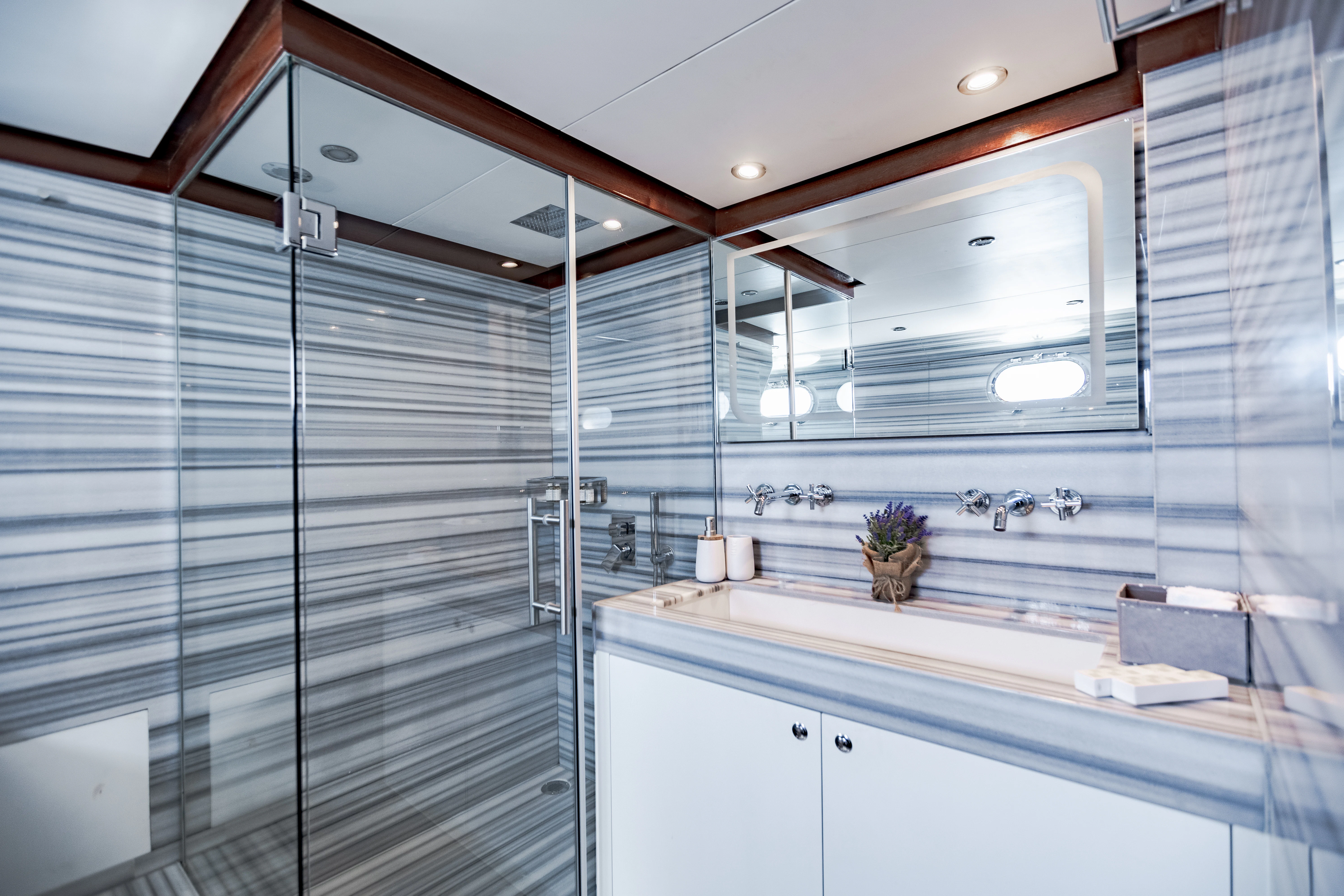 a bathroom with a glass shower aboard ALHAMBRA Yacht for Sale