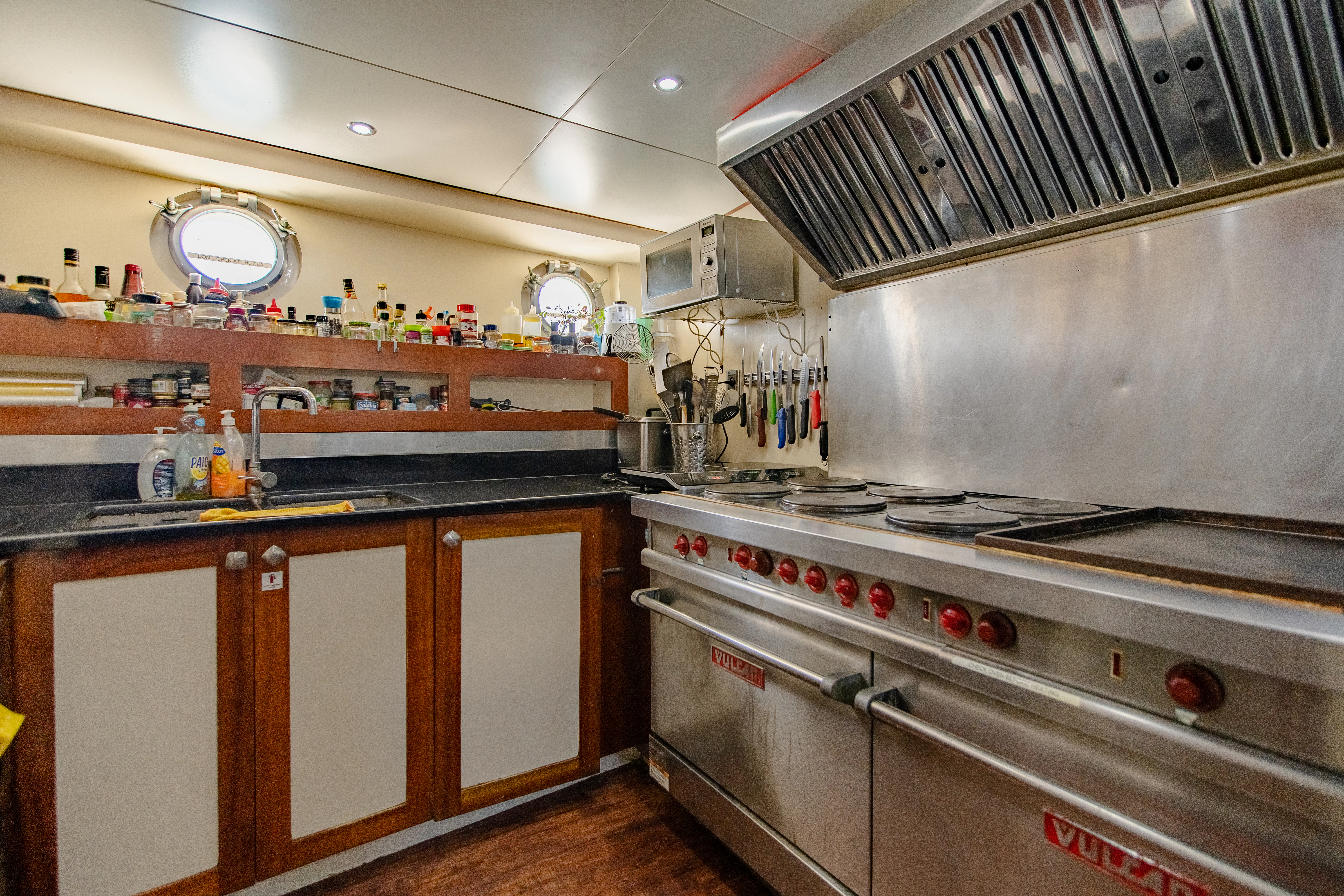 a kitchen with a stove and cabinets aboard ALHAMBRA Yacht for Sale