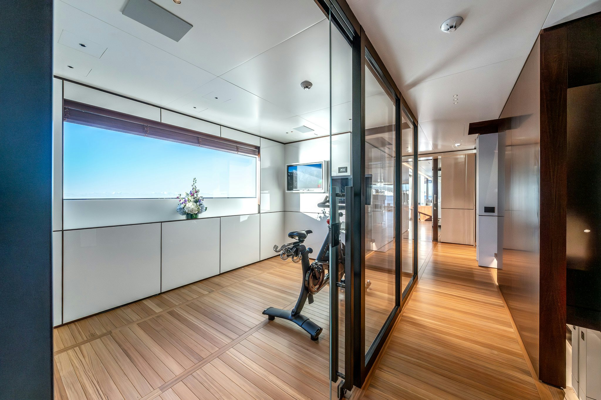 a room with a wood floor and a glass door aboard ALPHA WAVES Yacht for Charter
