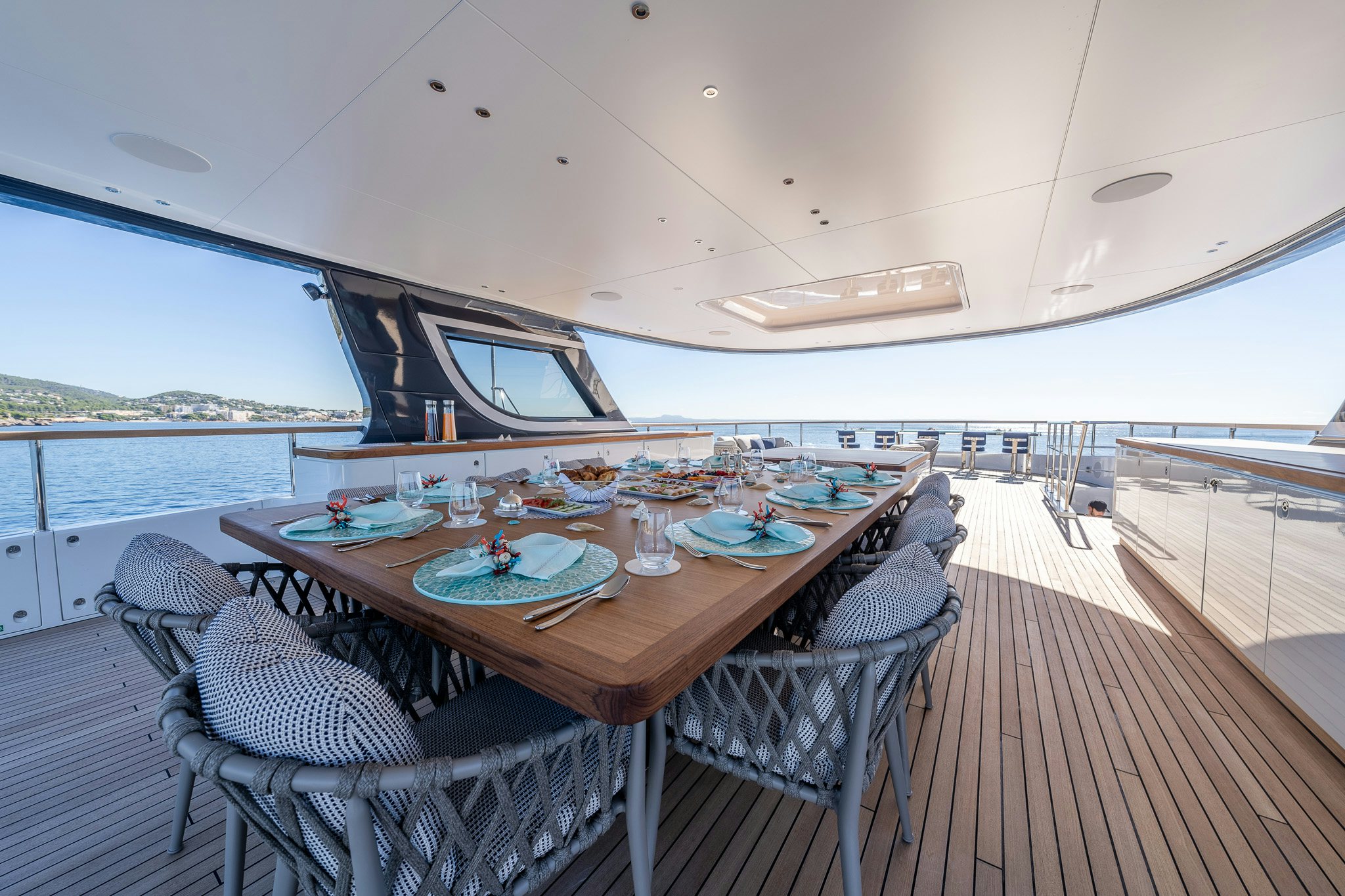 a table set for a meal on a boat aboard ALPHA WAVES Yacht for Charter