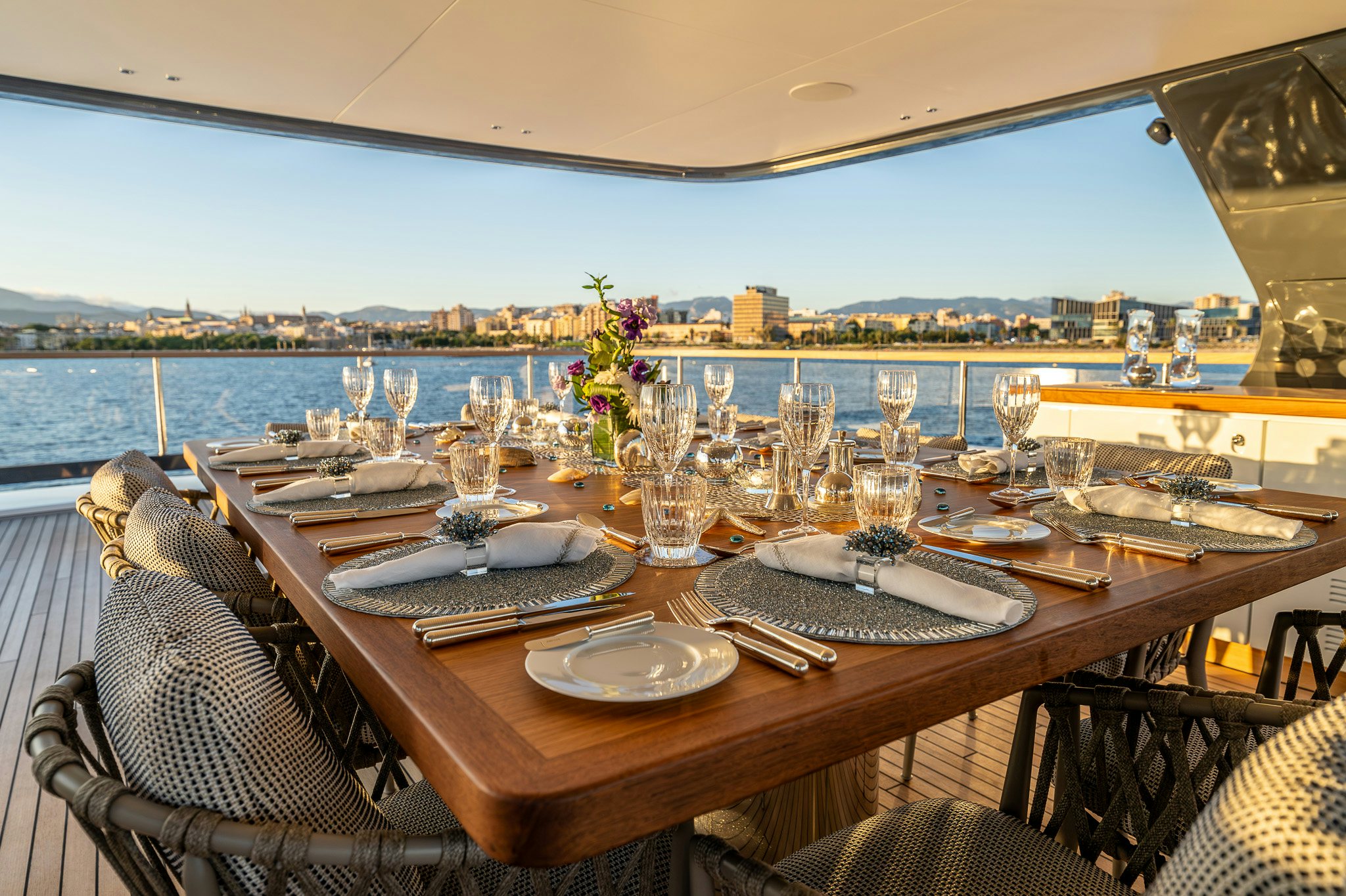 a table with plates and glasses on it aboard ALPHA WAVES Yacht for Charter