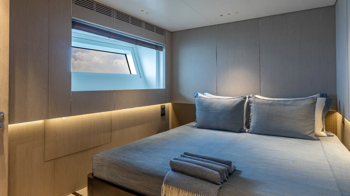 a bed with pillows aboard ALPHA WAVES Yacht for Charter