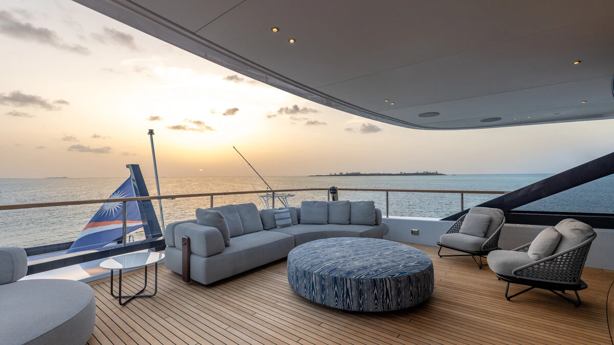 a room with a couch and a chair and a large body of water aboard ALPHA WAVES Yacht for Charter