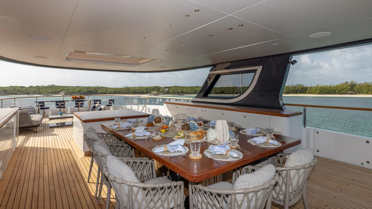 a dining table on a deck aboard ALPHA WAVES Yacht for Charter