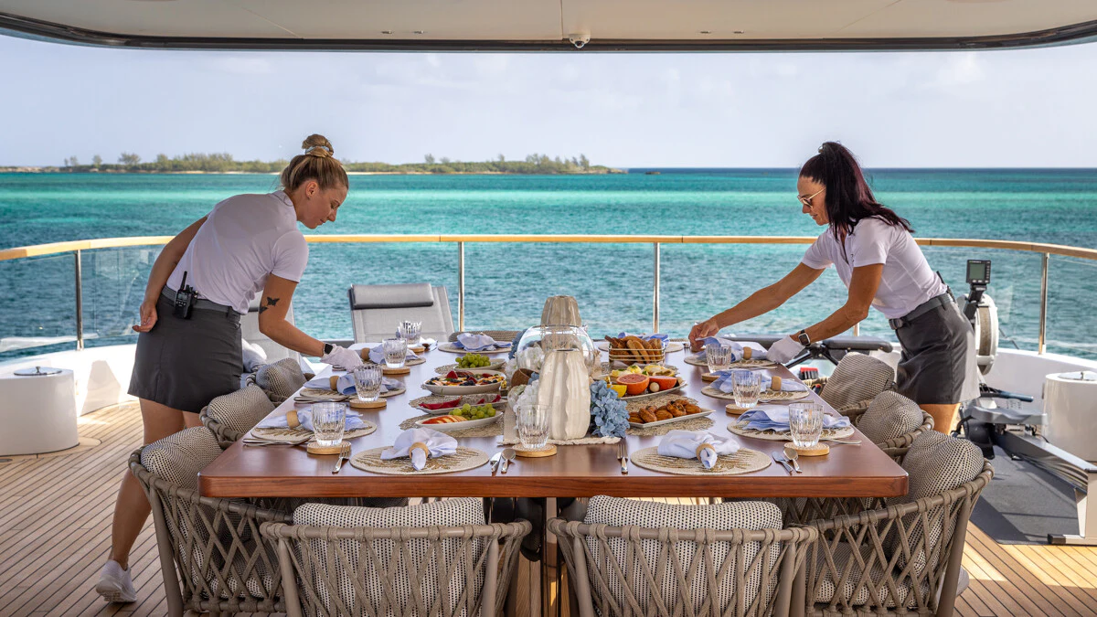 a couple of people sitting at a table with food on it aboard ALPHA WAVES Yacht for Charter