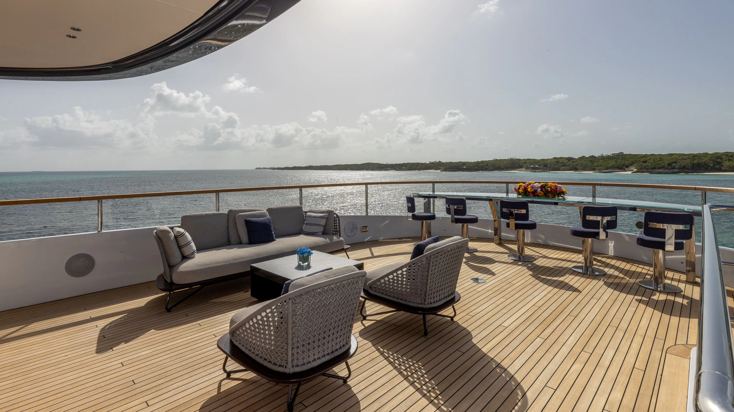 a large living room with a large balcony overlooking the ocean aboard ALPHA WAVES Yacht for Charter