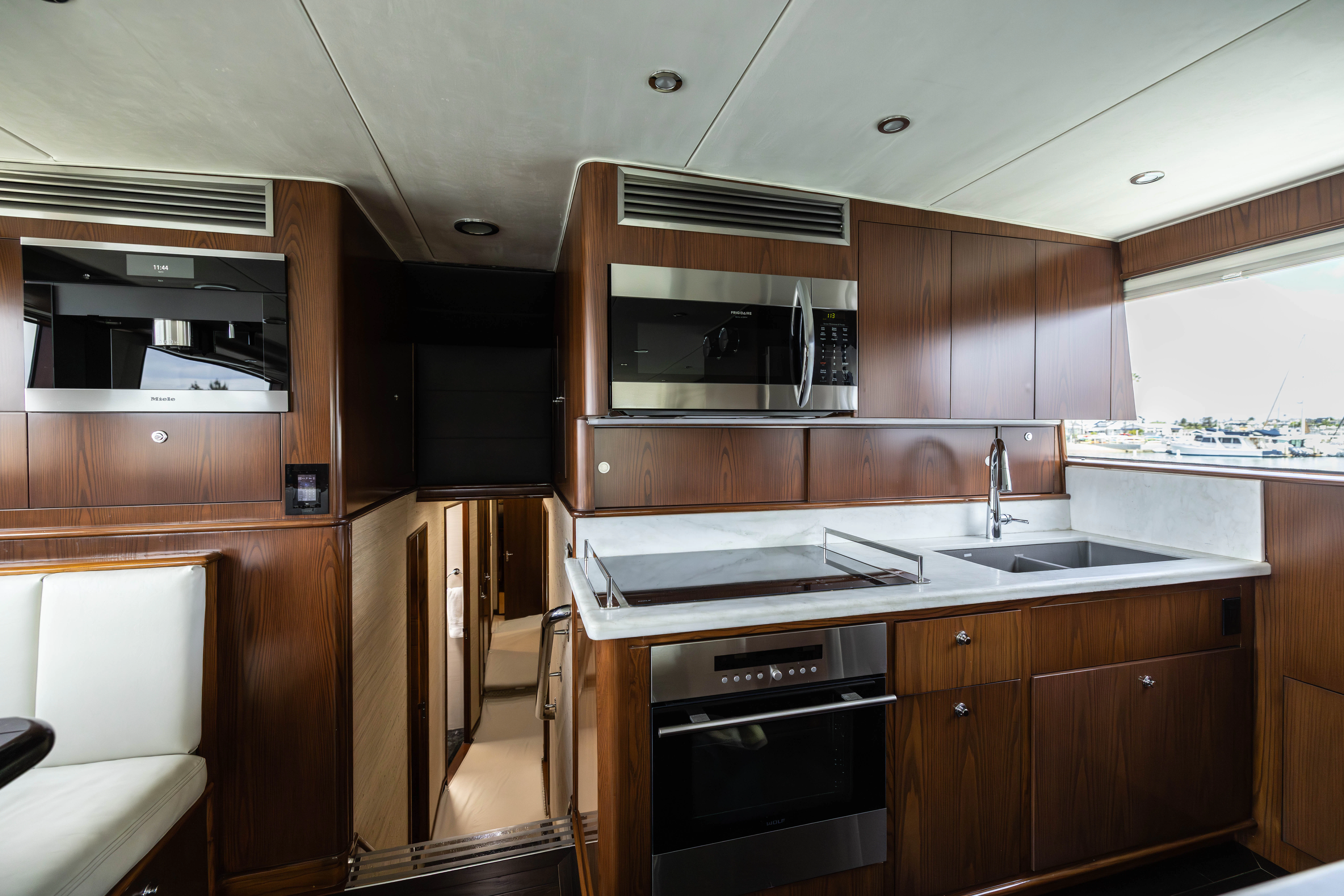 a kitchen with wooden cabinets aboard VERTIGO Yacht for Sale