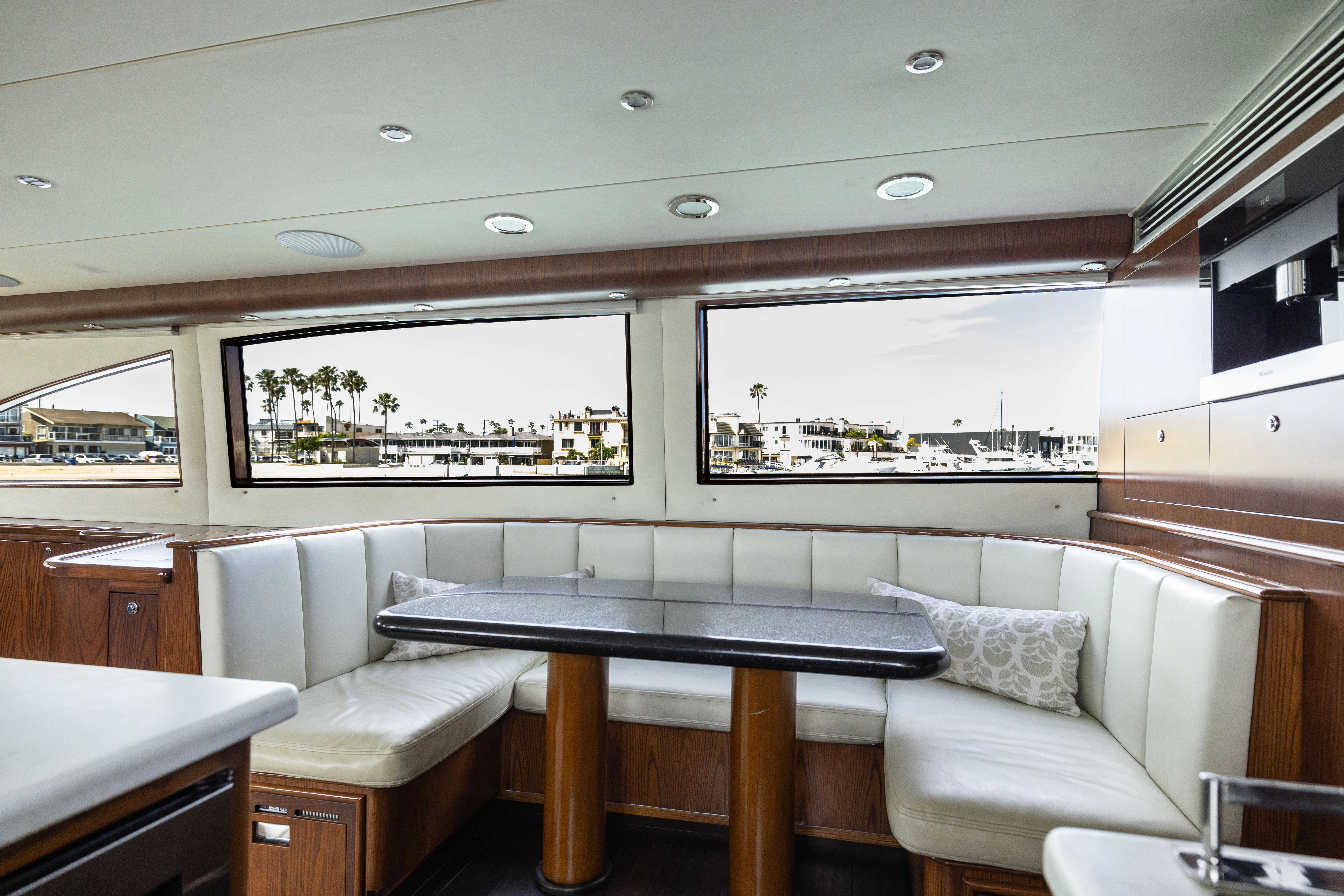 a living room with a table and couches aboard VERTIGO Yacht for Sale