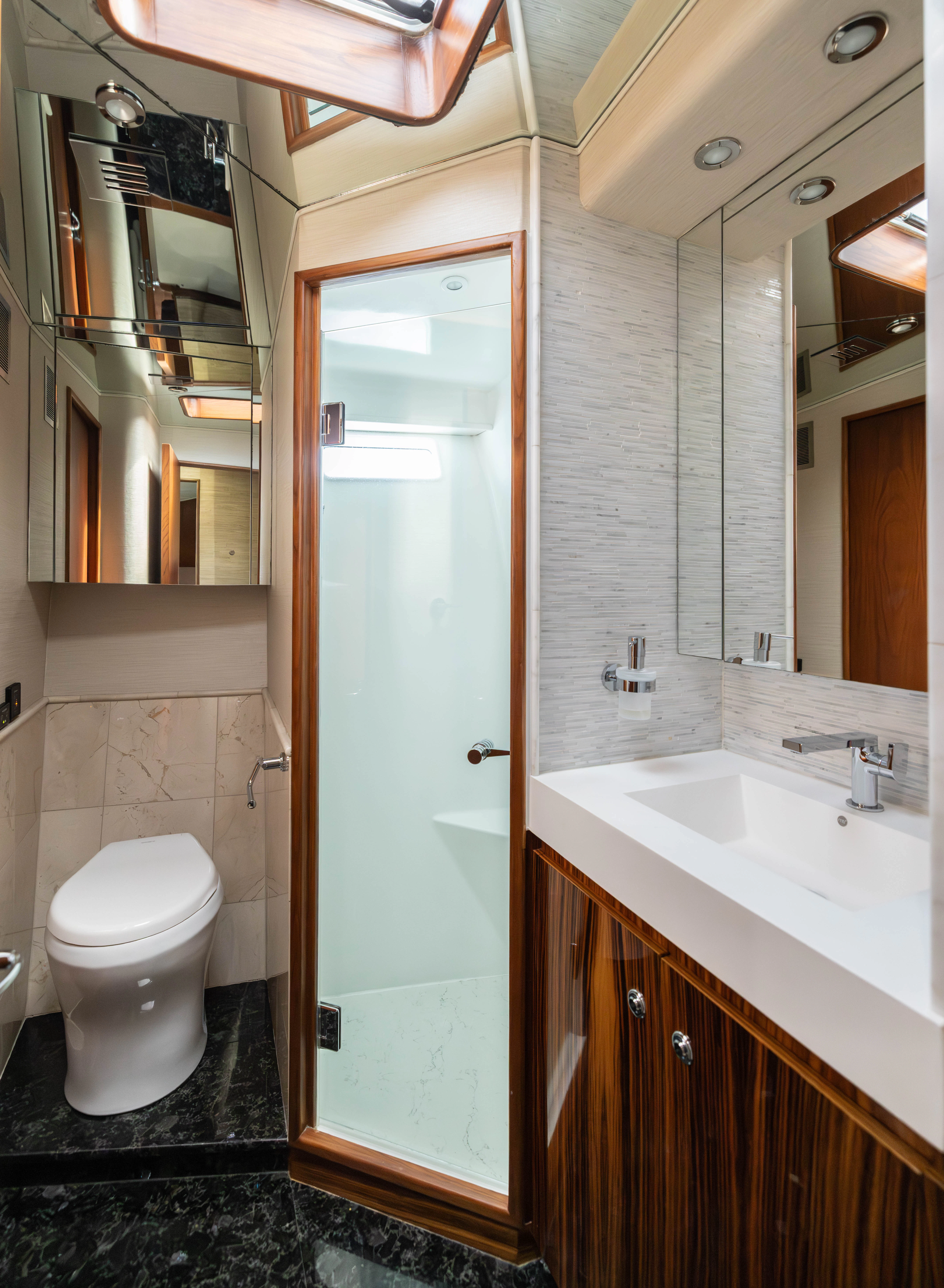 a bathroom with a toilet and sink aboard VERTIGO Yacht for Sale