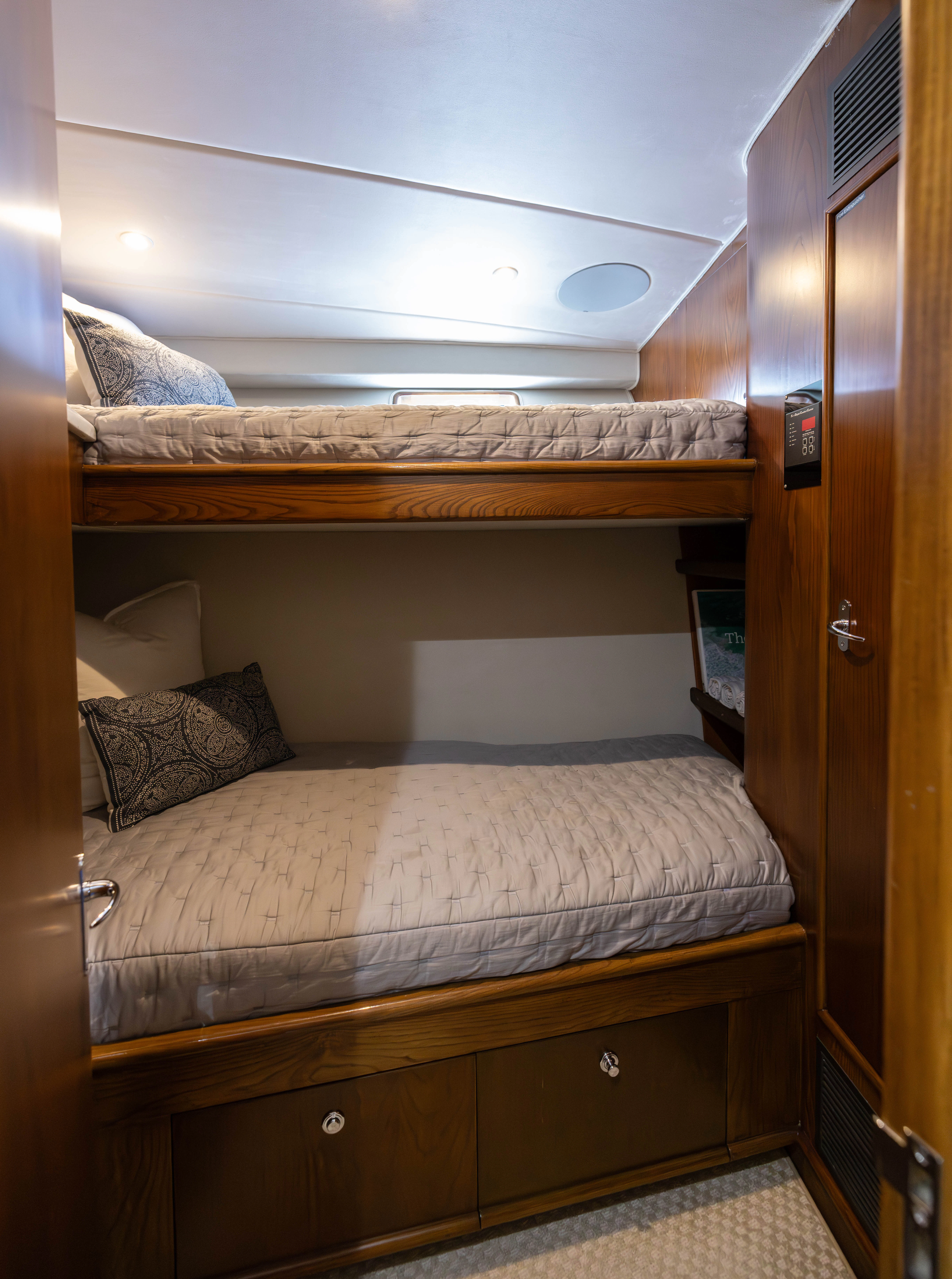 a bed with a wooden headboard aboard VERTIGO Yacht for Sale