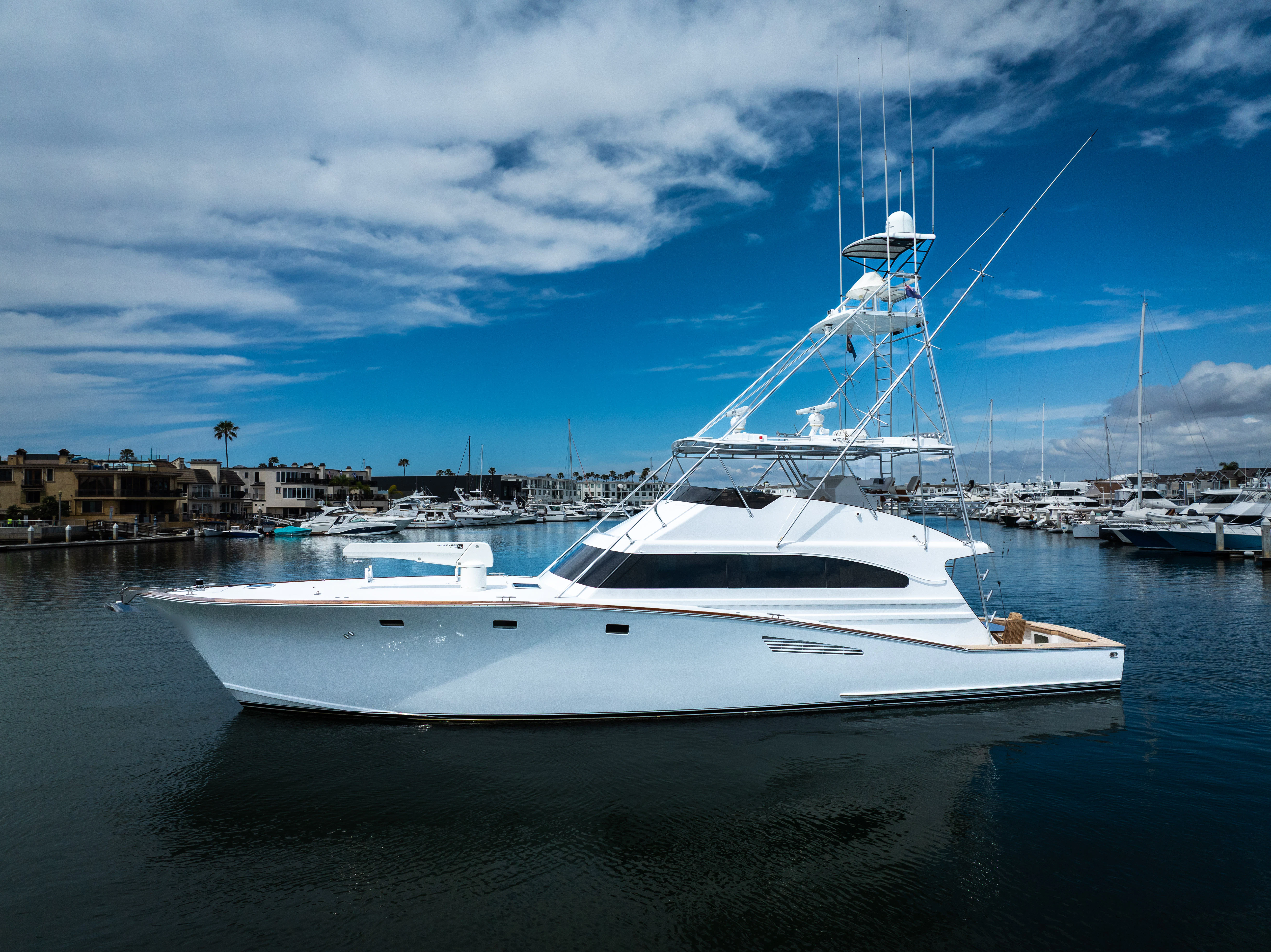 a white boat in a harbor aboard VERTIGO Yacht for Sale
