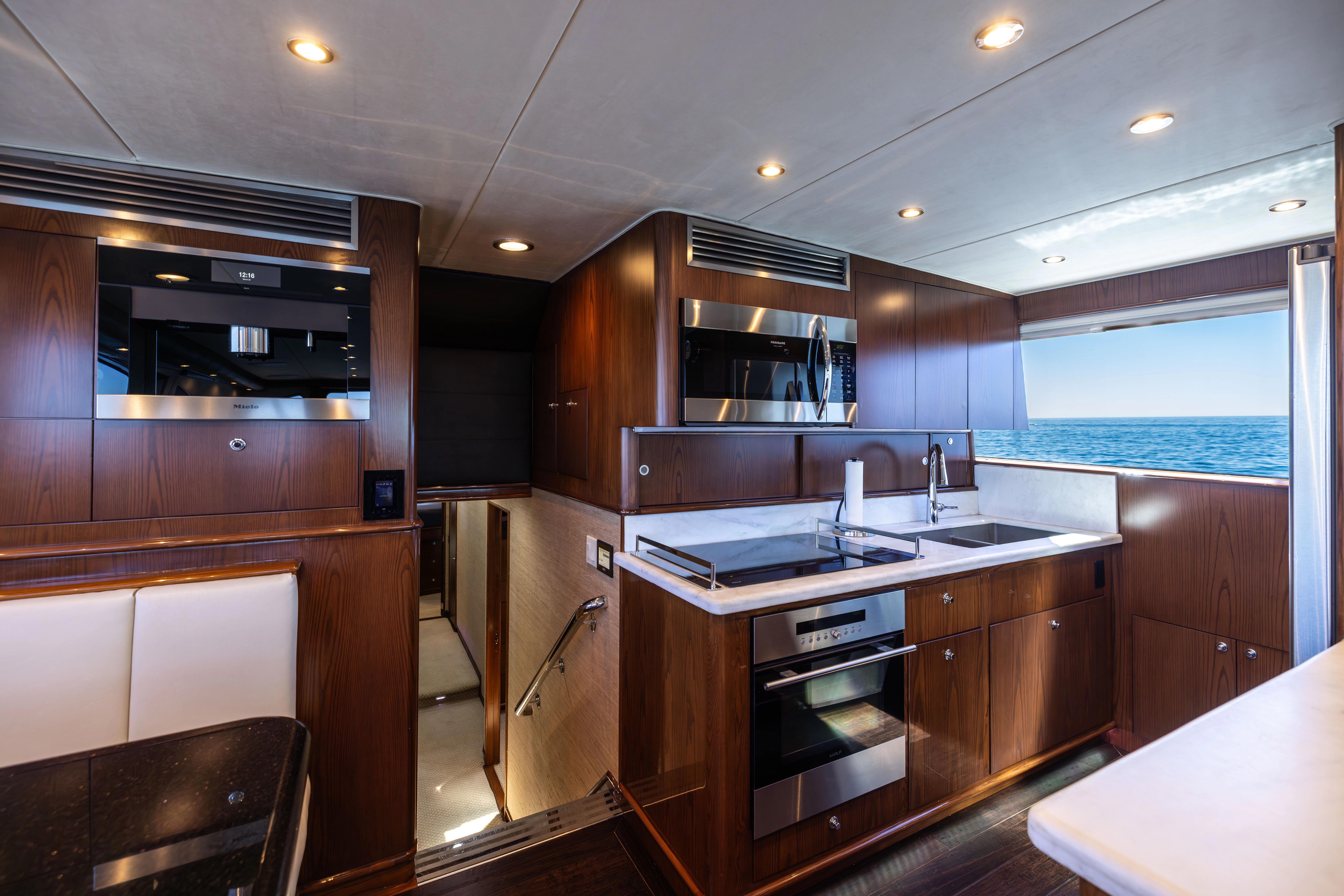 a kitchen with wooden cabinets aboard VERTIGO Yacht for Sale