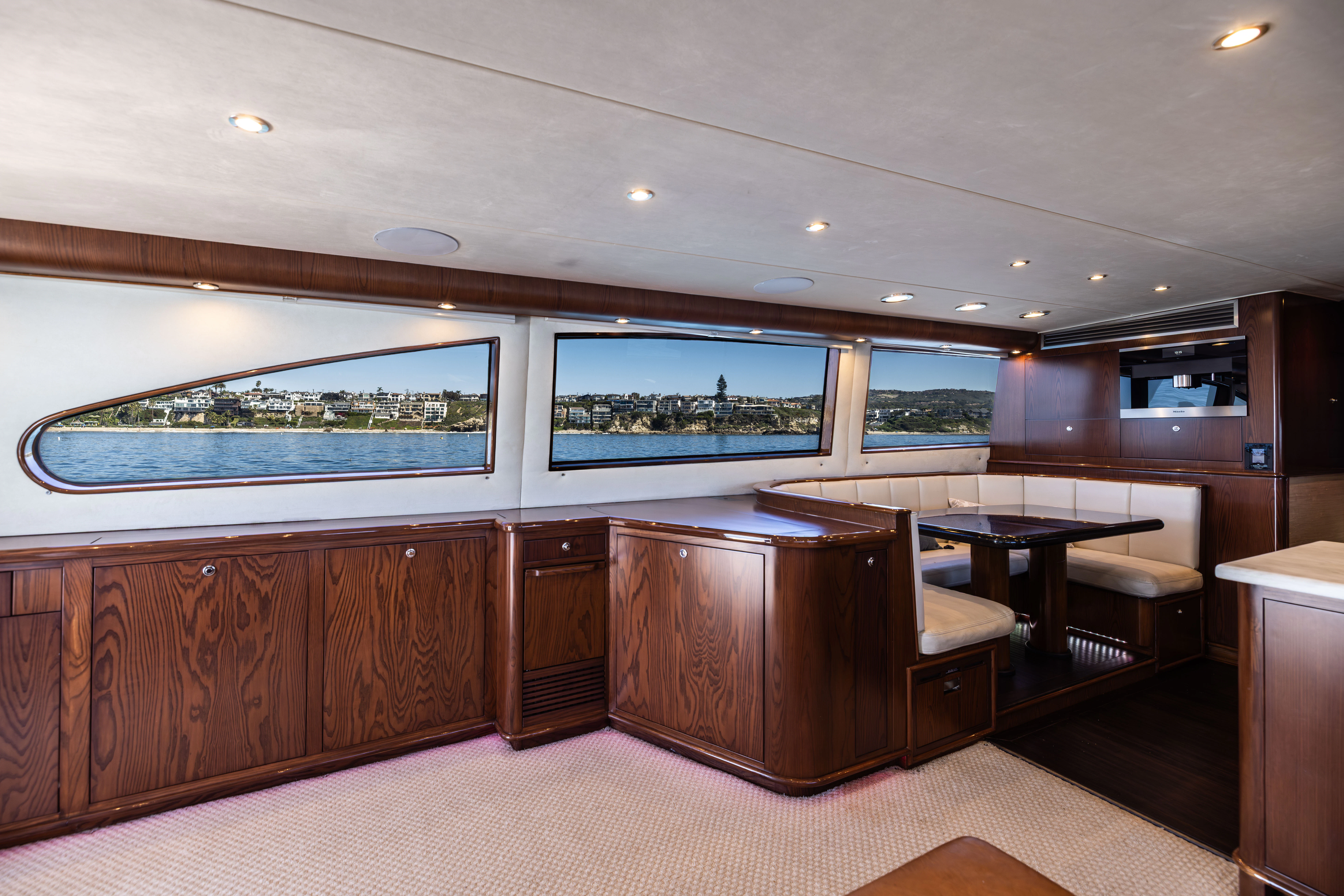 a room with a large window and a table with chairs aboard VERTIGO Yacht for Sale