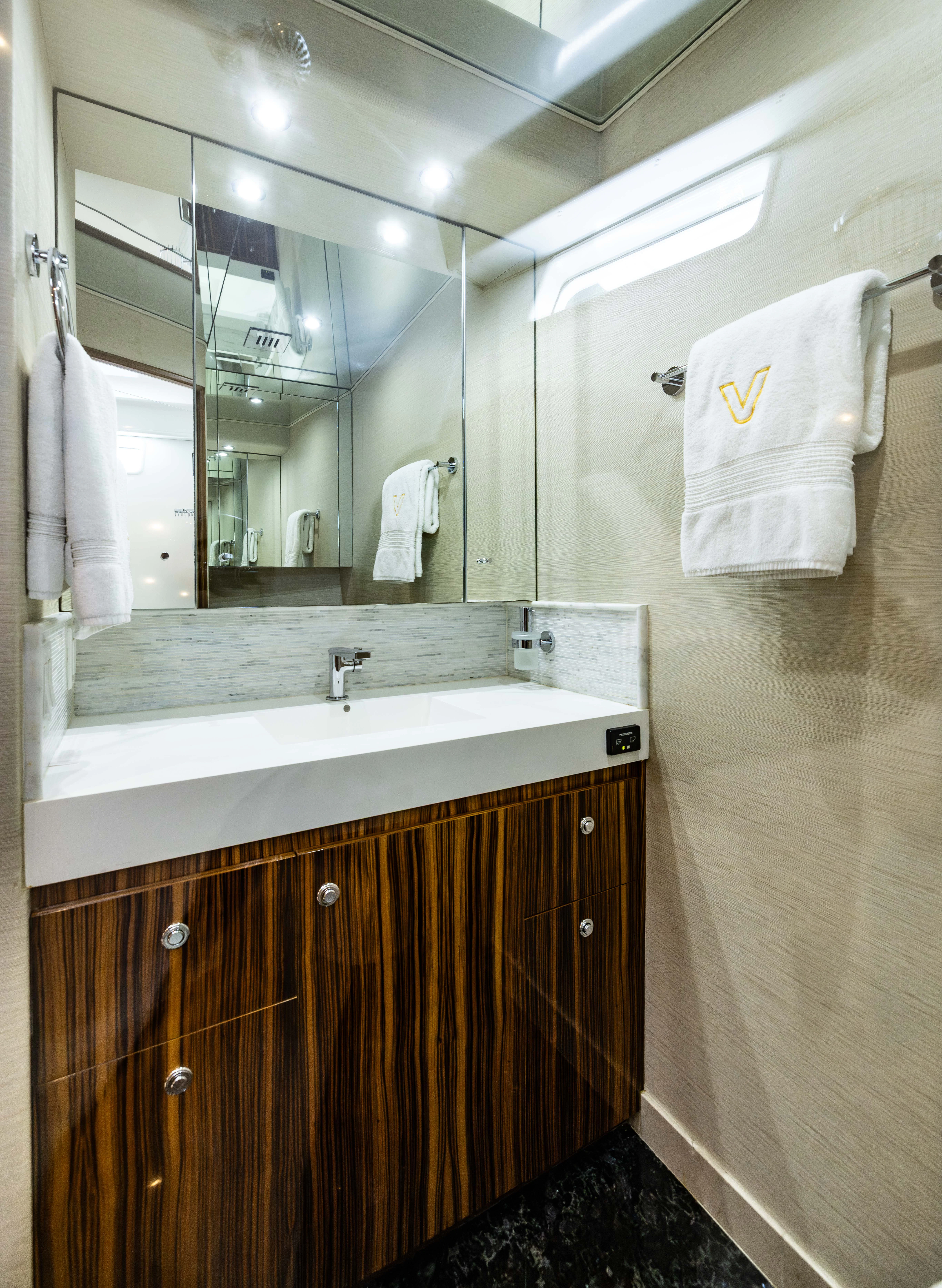 a bathroom with a large mirror aboard VERTIGO Yacht for Sale