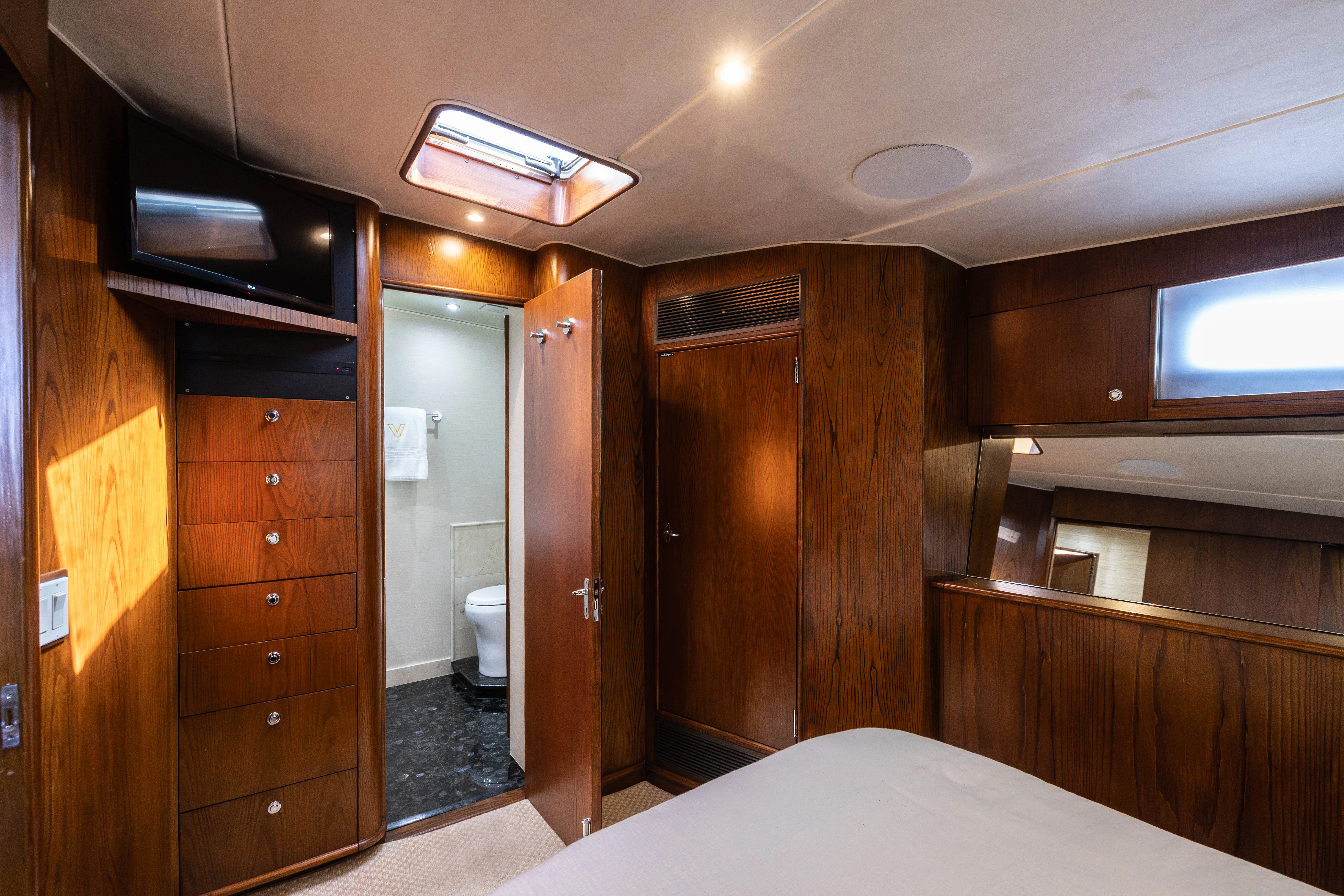 a room with a bed and a closet aboard VERTIGO Yacht for Sale