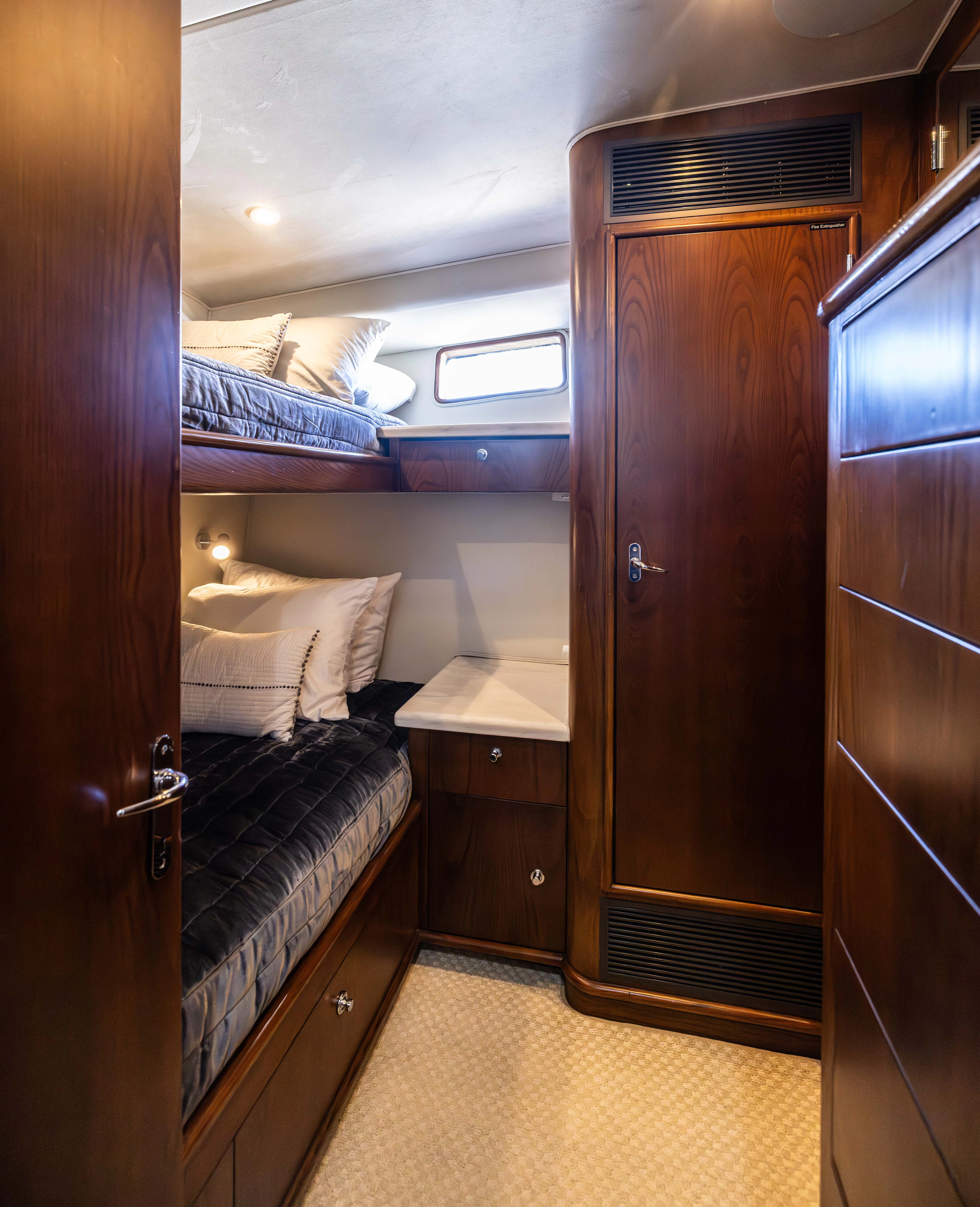 a room with a bed and a desk aboard VERTIGO Yacht for Sale