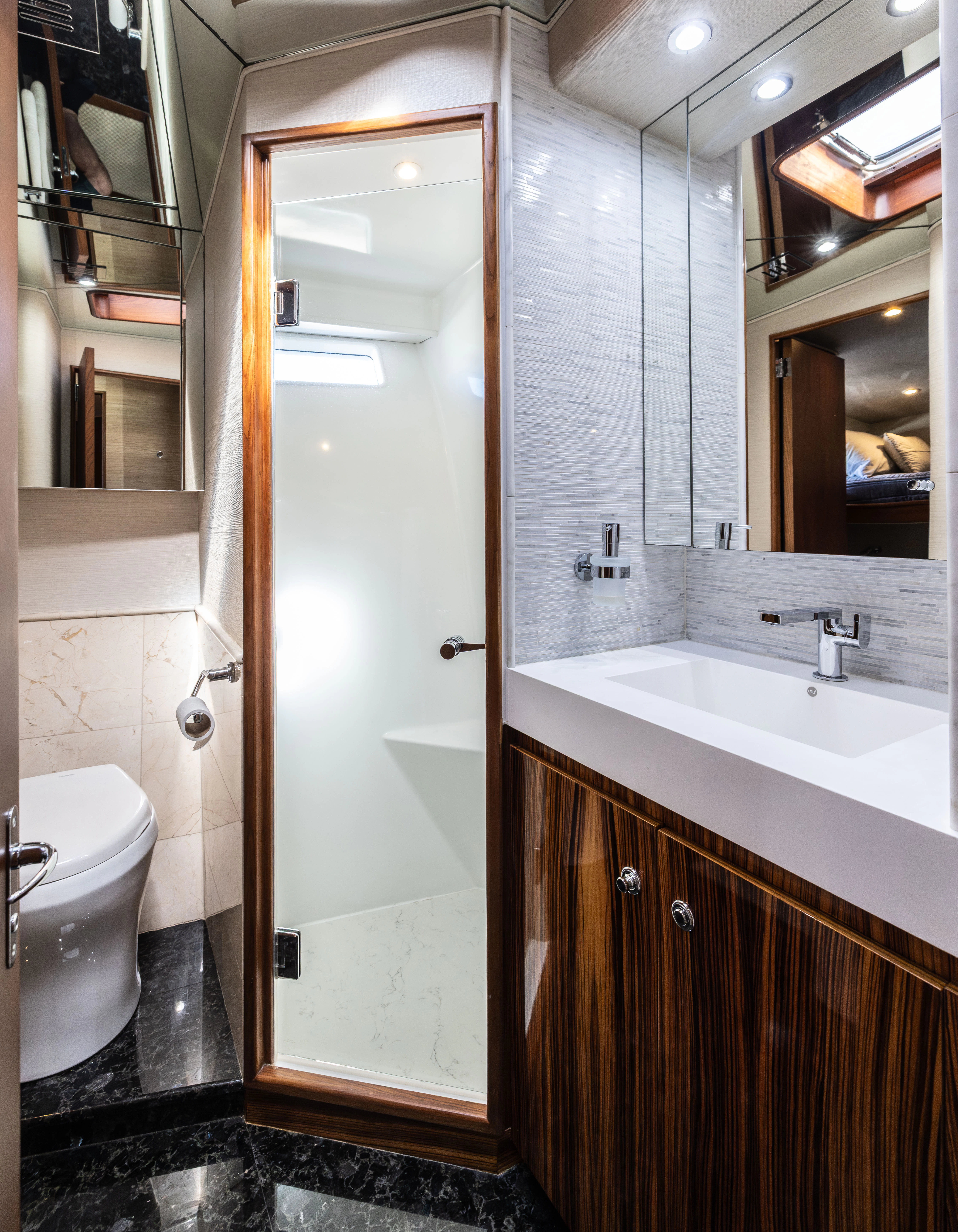 a bathroom with a shower and sink aboard VERTIGO Yacht for Sale