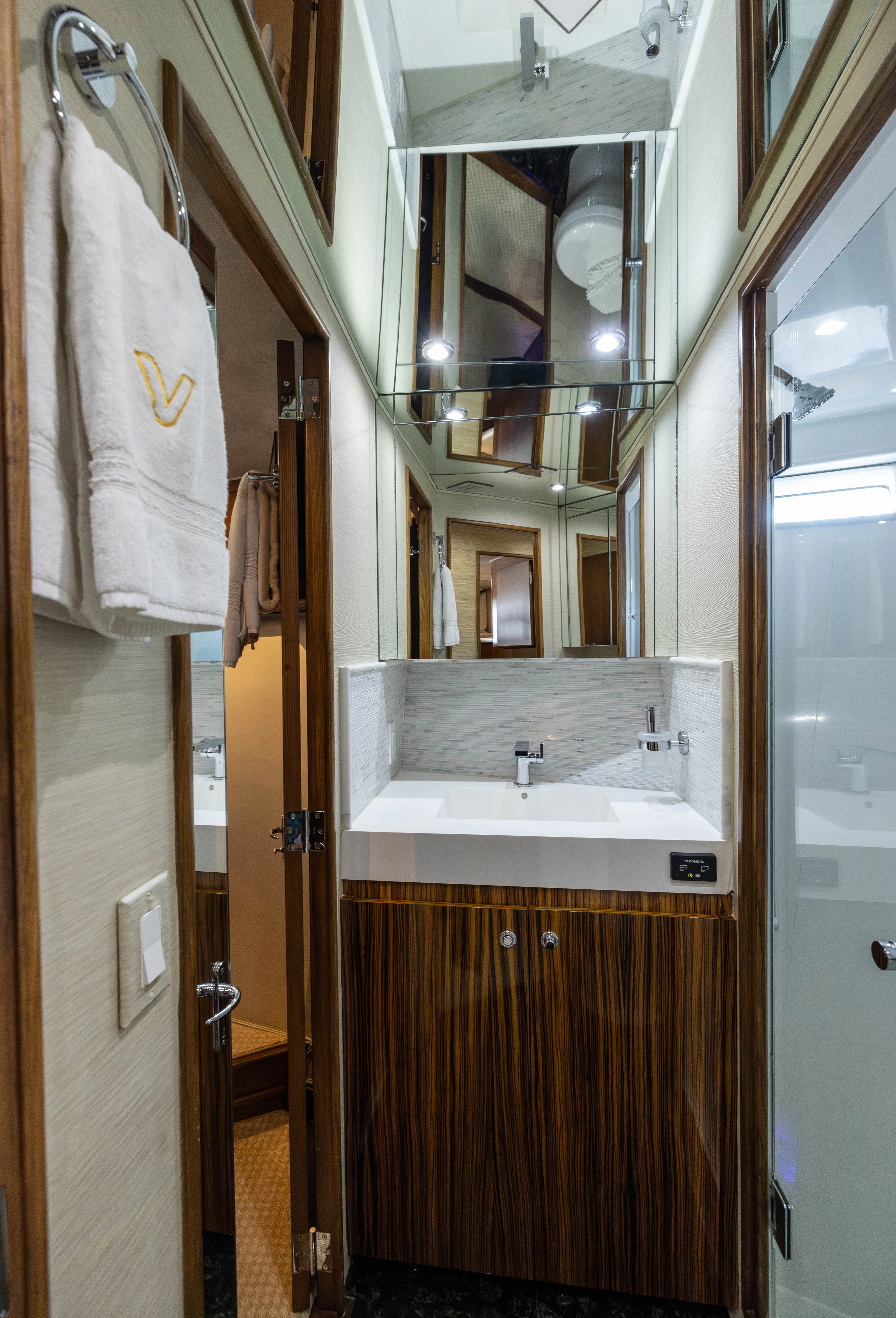 a bathroom with a sink and a mirror aboard VERTIGO Yacht for Sale