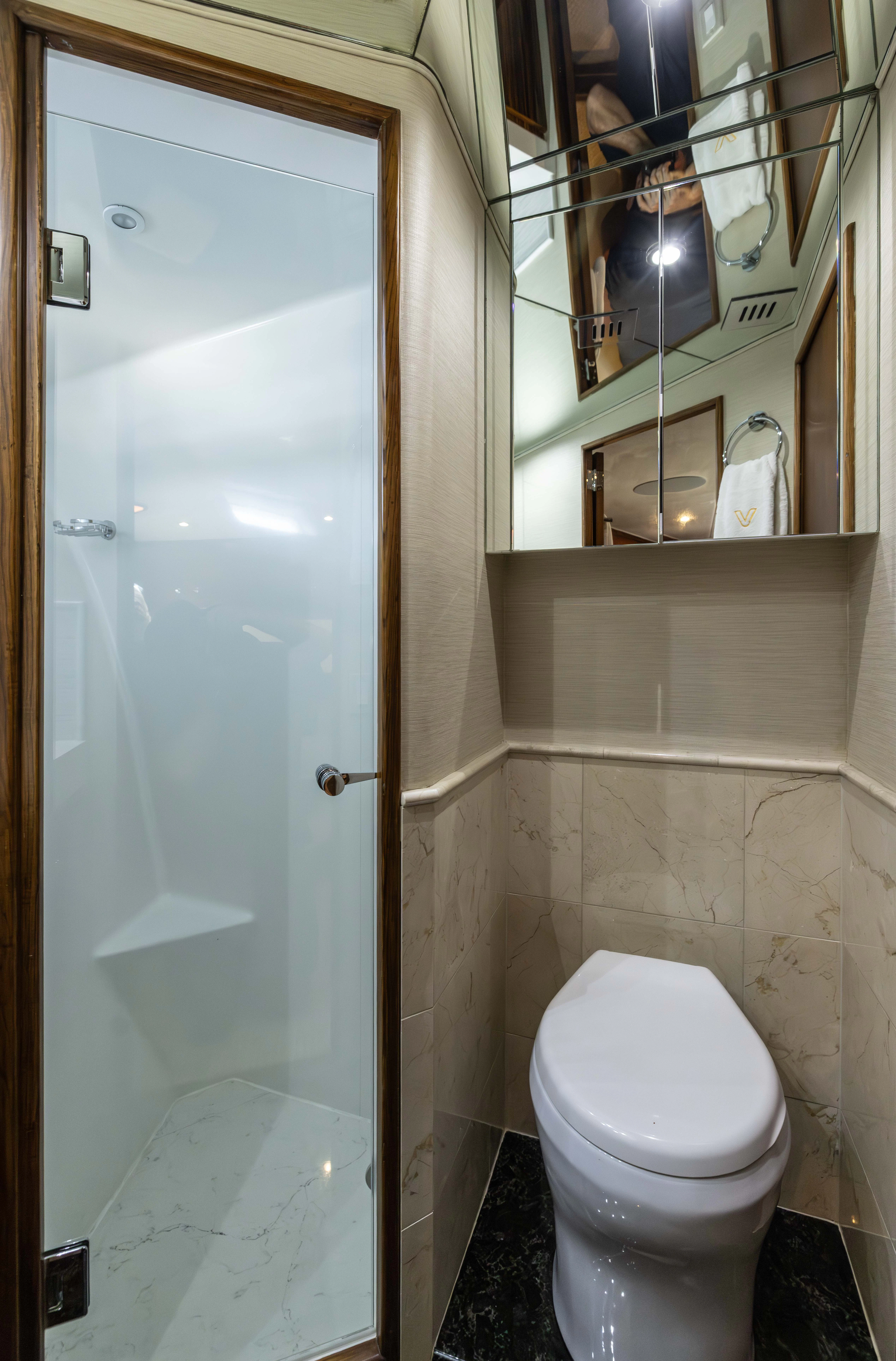 a bathroom with a toilet and a shower aboard VERTIGO Yacht for Sale