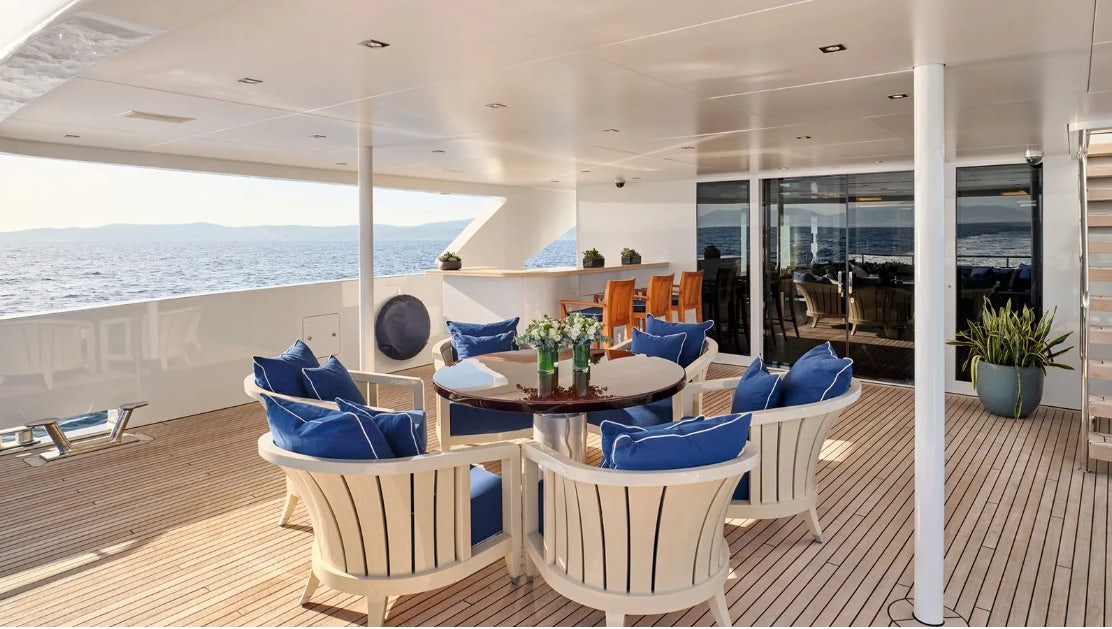 a room with a table and chairs aboard TIMBUKTU Yacht for Charter
