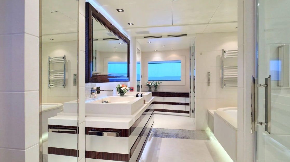 a bathroom with a large mirror aboard TIMBUKTU Yacht for Charter