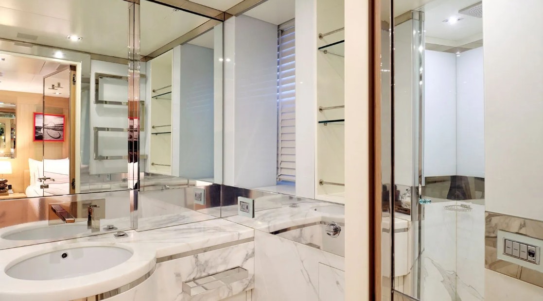 a bathroom with a large mirror aboard TIMBUKTU Yacht for Charter