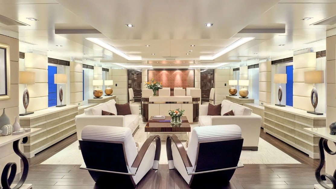 a living room with a large white couch and a table aboard TIMBUKTU Yacht for Charter
