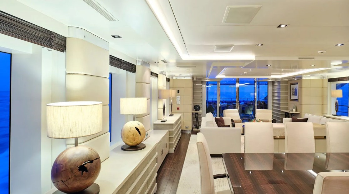 a room with a large white vase and chairs aboard TIMBUKTU Yacht for Charter