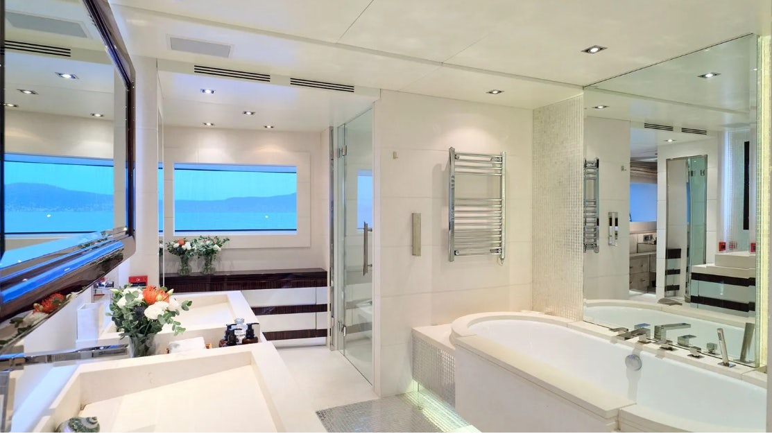 a bathroom with a large mirror aboard TIMBUKTU Yacht for Charter