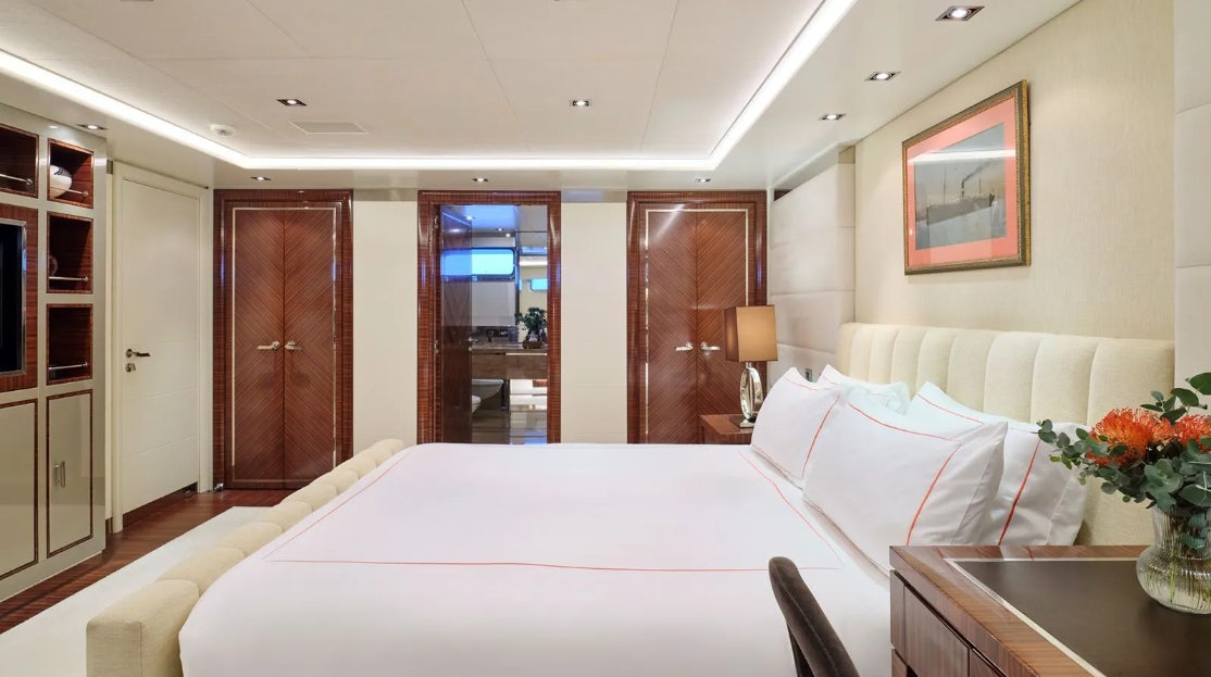 a hotel room with a bed and a table aboard TIMBUKTU Yacht for Charter