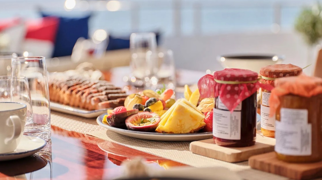 a table with food and drinks on it aboard TIMBUKTU Yacht for Charter