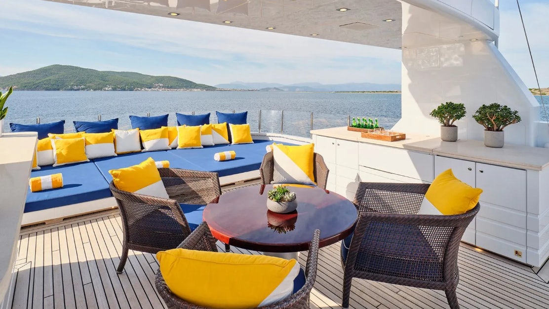 a patio with a table and chairs aboard TIMBUKTU Yacht for Charter