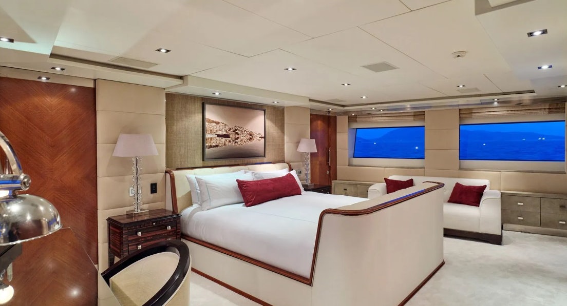 a room with a bed and a television aboard TIMBUKTU Yacht for Charter
