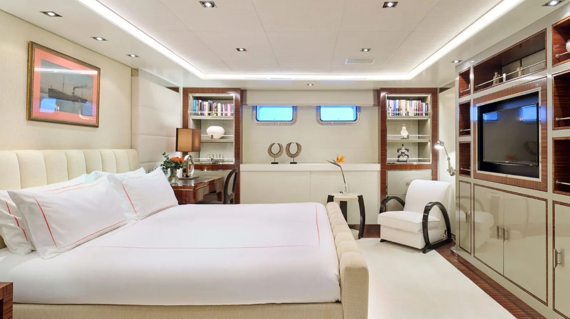 a room with a bed and a tv aboard TIMBUKTU Yacht for Charter