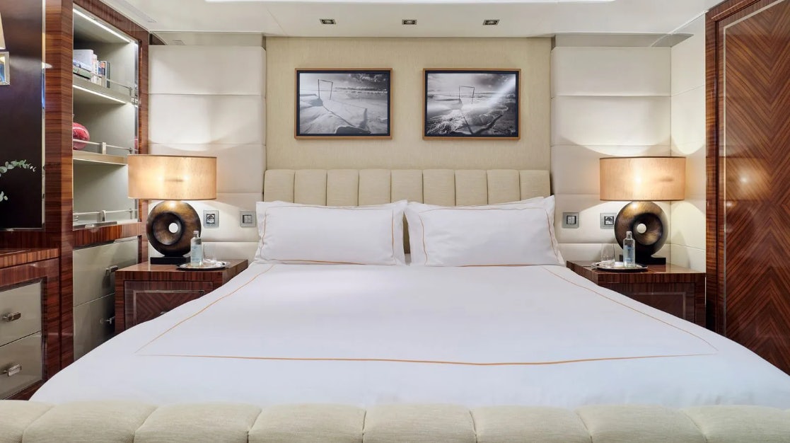 a bed with white sheets aboard TIMBUKTU Yacht for Charter