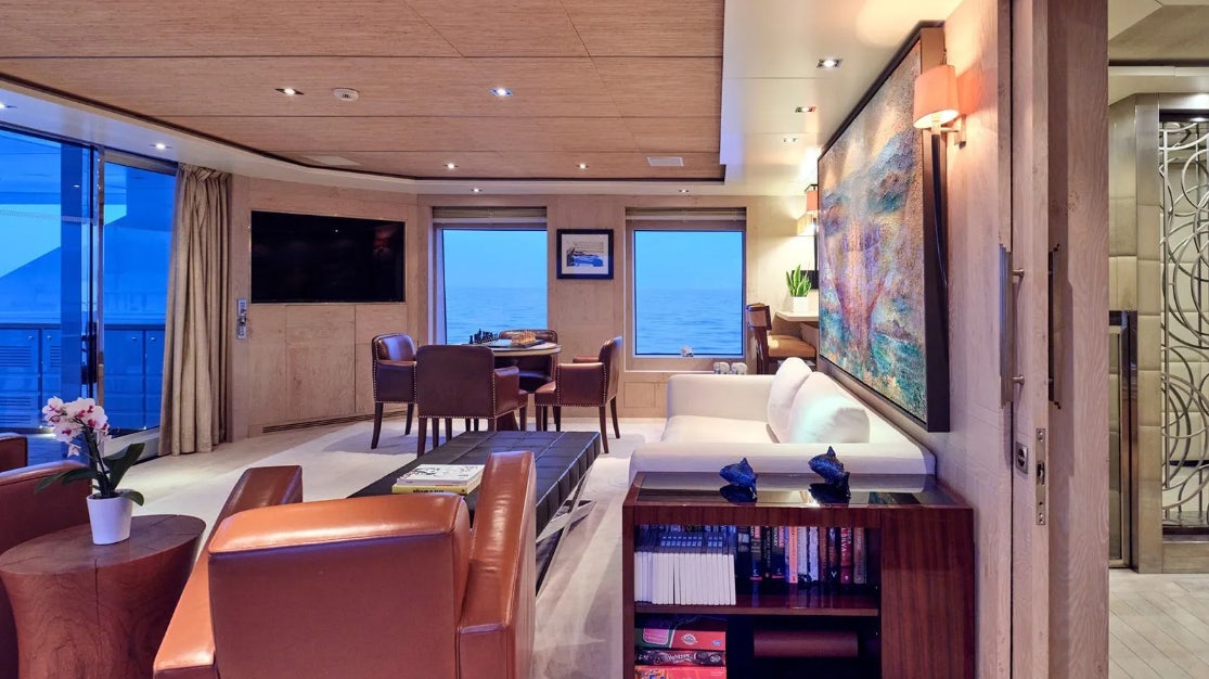 a room with a table and chairs aboard TIMBUKTU Yacht for Charter