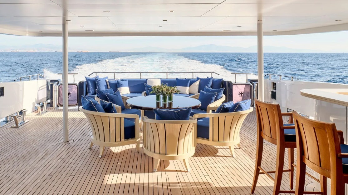 a patio with chairs and tables aboard TIMBUKTU Yacht for Charter