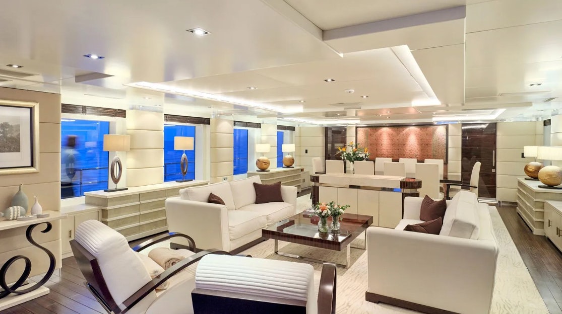 a living room with white furniture aboard TIMBUKTU Yacht for Charter