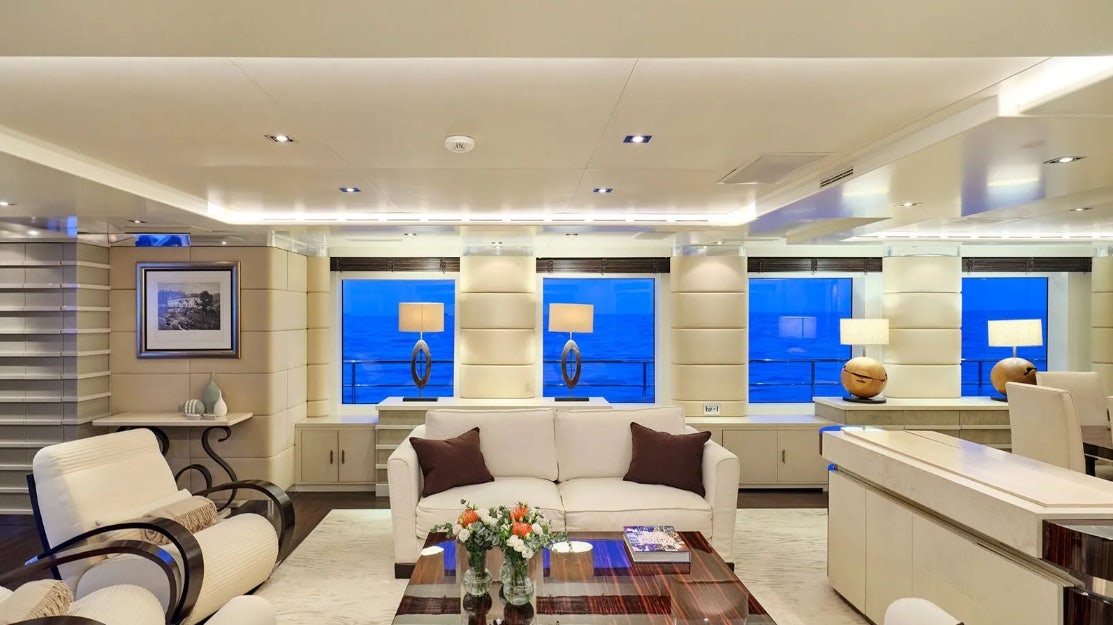 a living room with a white couch and a table aboard TIMBUKTU Yacht for Charter