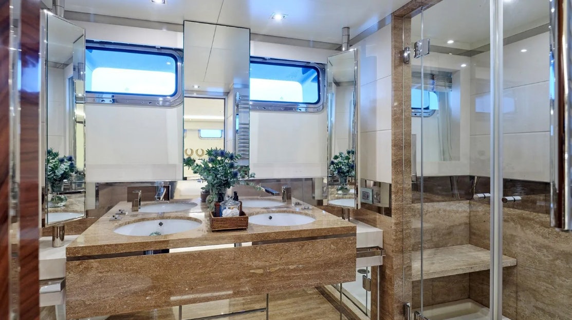 a bathroom with a countertop sink and a shower unit aboard TIMBUKTU Yacht for Charter
