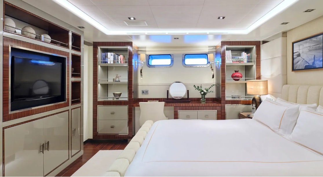 a room with a bed and a tv aboard TIMBUKTU Yacht for Charter